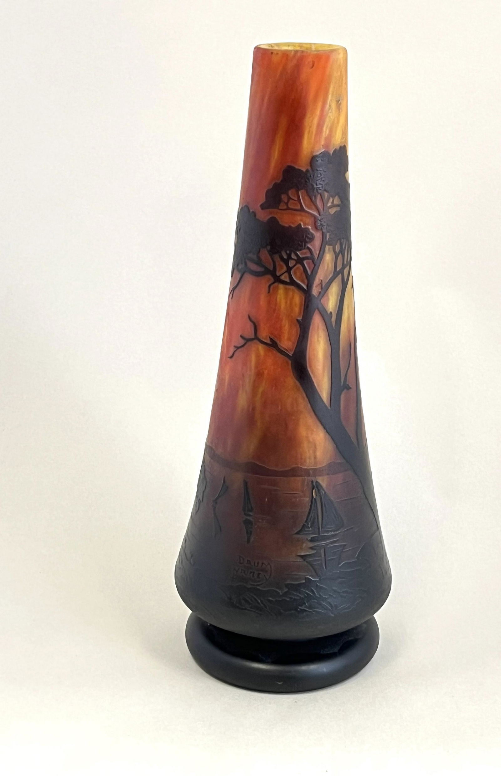 Daum lake scene cameo vase: Daum reverse trumpet footed vase, lake with sale boats on dark amber mottled background; signed in cameo Daum Nancy; 9 1/2" ht. CONDITION: no chips, cracks, repairs or material defects found. Jaremos