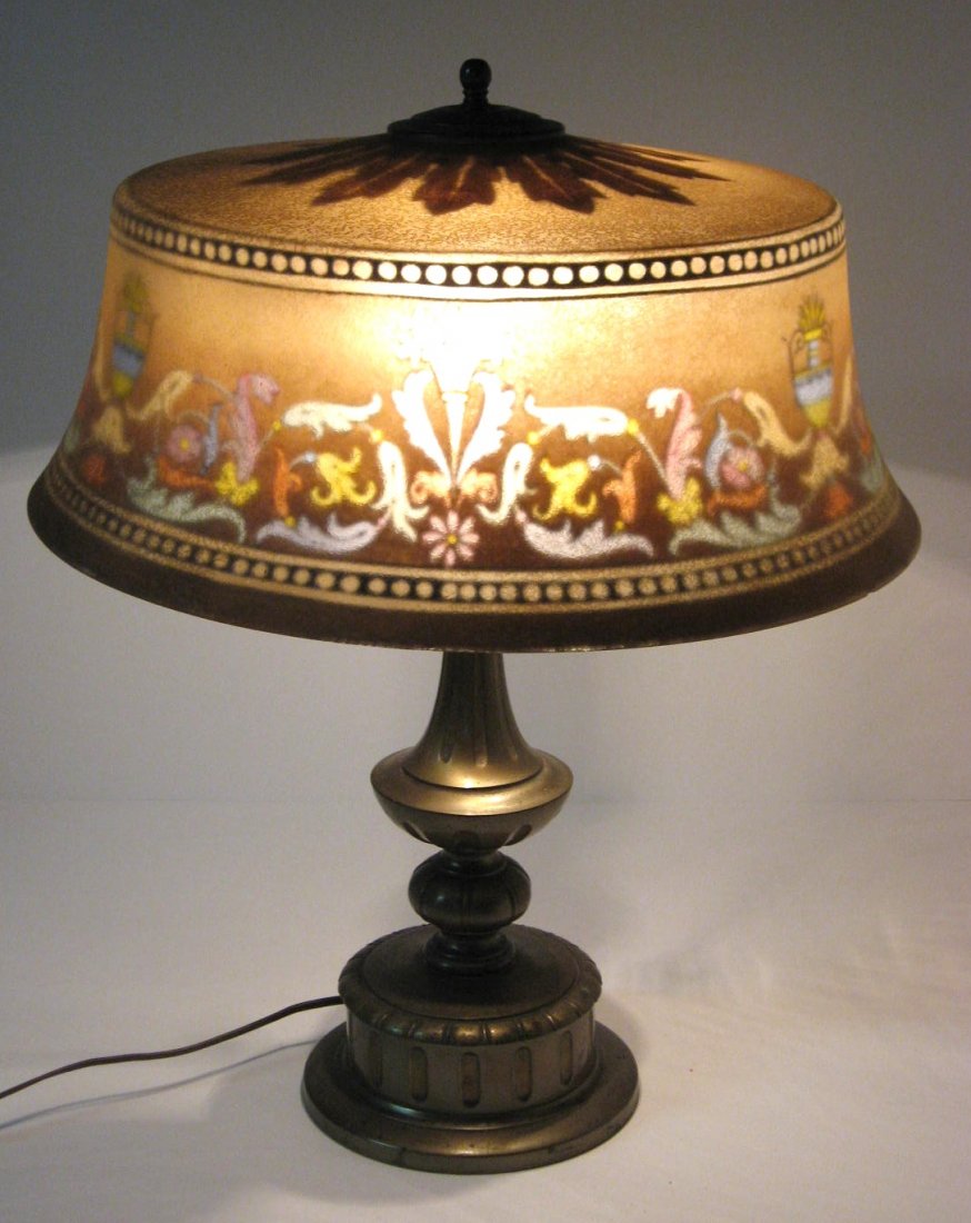 Pairpoint reverse painted lamp,: Bombay shade in brown decorated with colorful scrolling and urns, shade signed The Pairpoint Co. base stamped with the diamond P trademark, 17" wide by 21" ht. CONDITION: one socket without pull chain