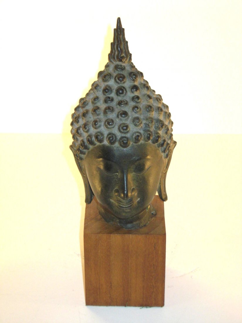 Bronze bust of a Hindu god,: very old bronze set on a home made wood pedestal, 13 1/2" ht. CONDITION: un-even edge at the base of the neck.