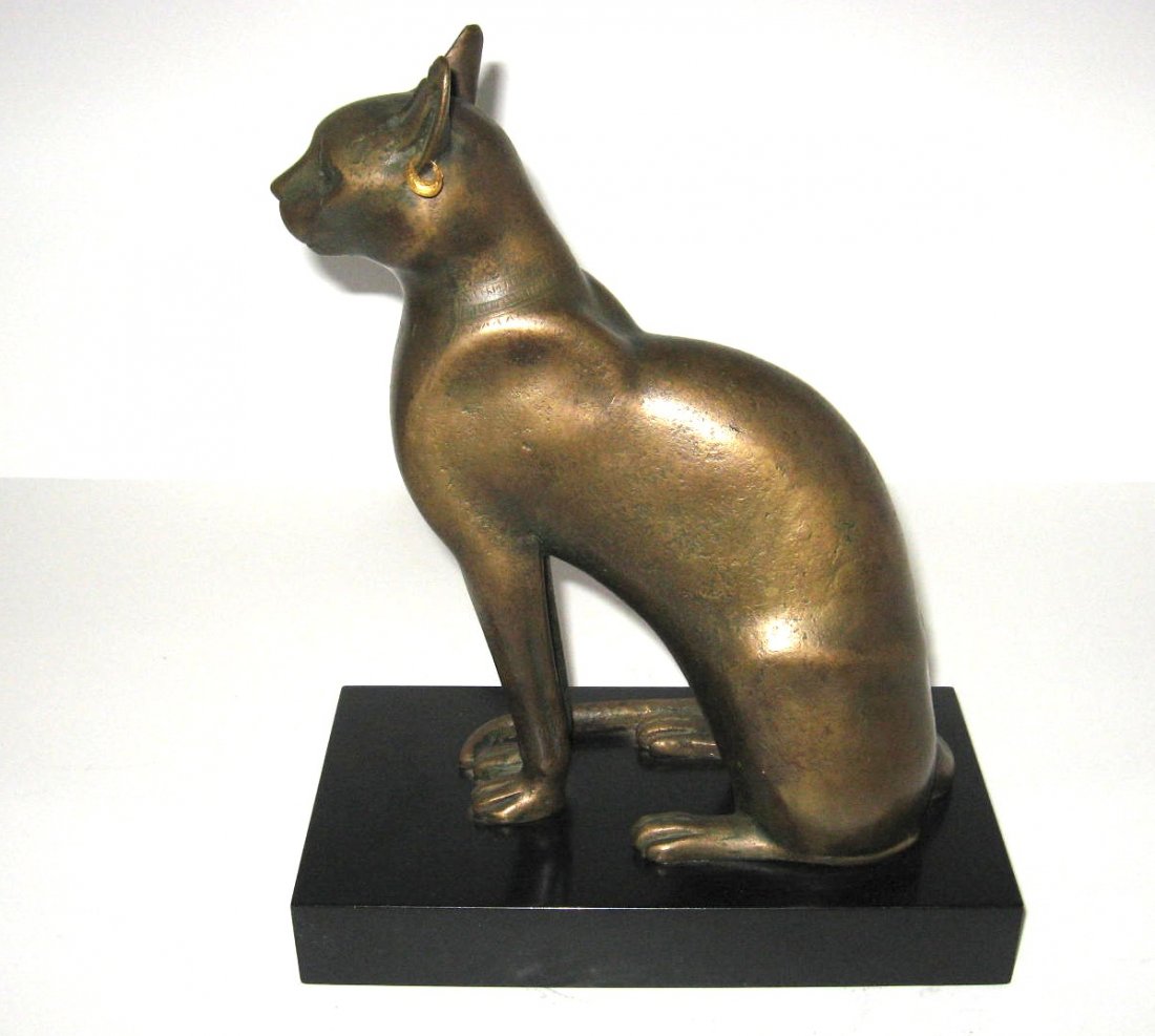 Bronze of Bastet the Egyptian cat god,: bronze cat set on a black base, produced for the Metropolitan Museum of Art, marked MMA 156.16, 12" ht. CONDITION: good with no chips cracks or repairs.