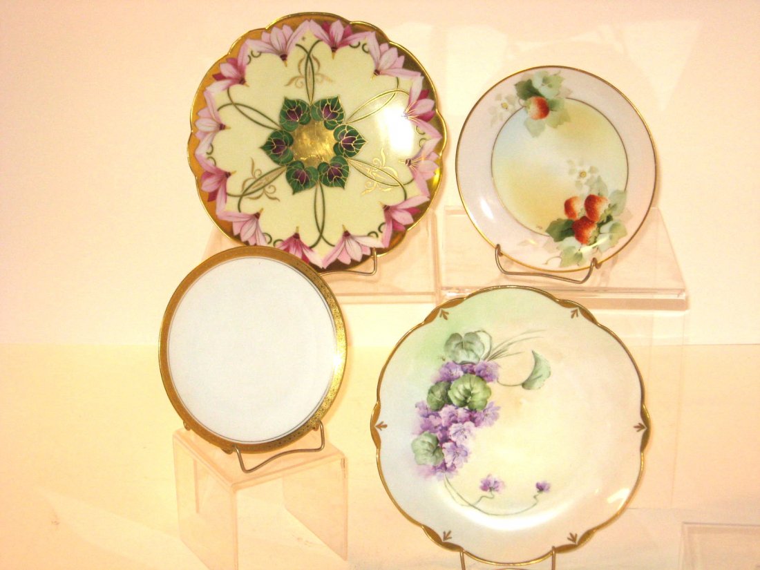Four Pickard porcelain plates,: including a rare Henry Reu artist signed plate with a colorful Art Nouveau design, all marked, largest 9" wide.
