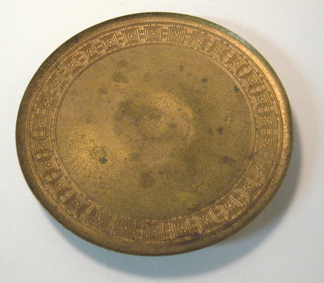 Louis Tiffany bronze footed plate,: decorated with a stylized box border, signed Tiffany Studios New York 1744, 10" wide. CONDITION: good with no issues.
