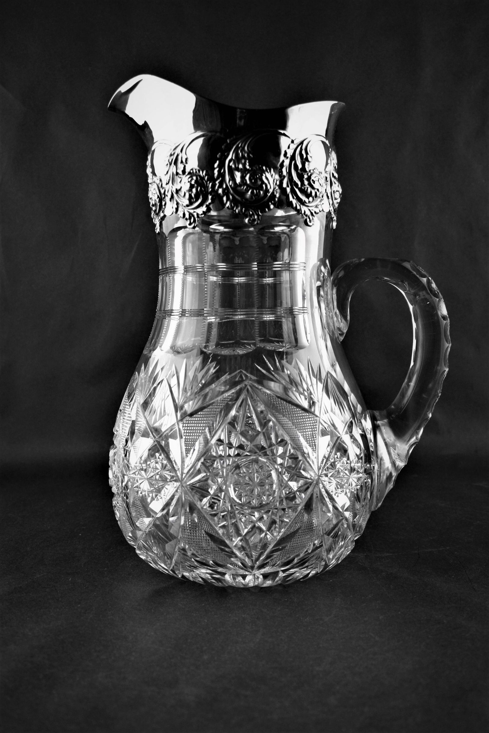 Sterling Rim Pitcher.: Fabulous Adelphi Sterling Rim Pitcher. Triple notched handle with a tic tac toe design on the middle notch. Sterling rim marked with the beehive for Adelphi Silver Company. Chip on body of above handl