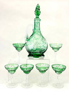 Stevens and Williams Decanter Set: Stevens and Williams Decanter set in green cut to clear consisting of a decanter bottle with twist stopper and six matching goblets, 12" ht.