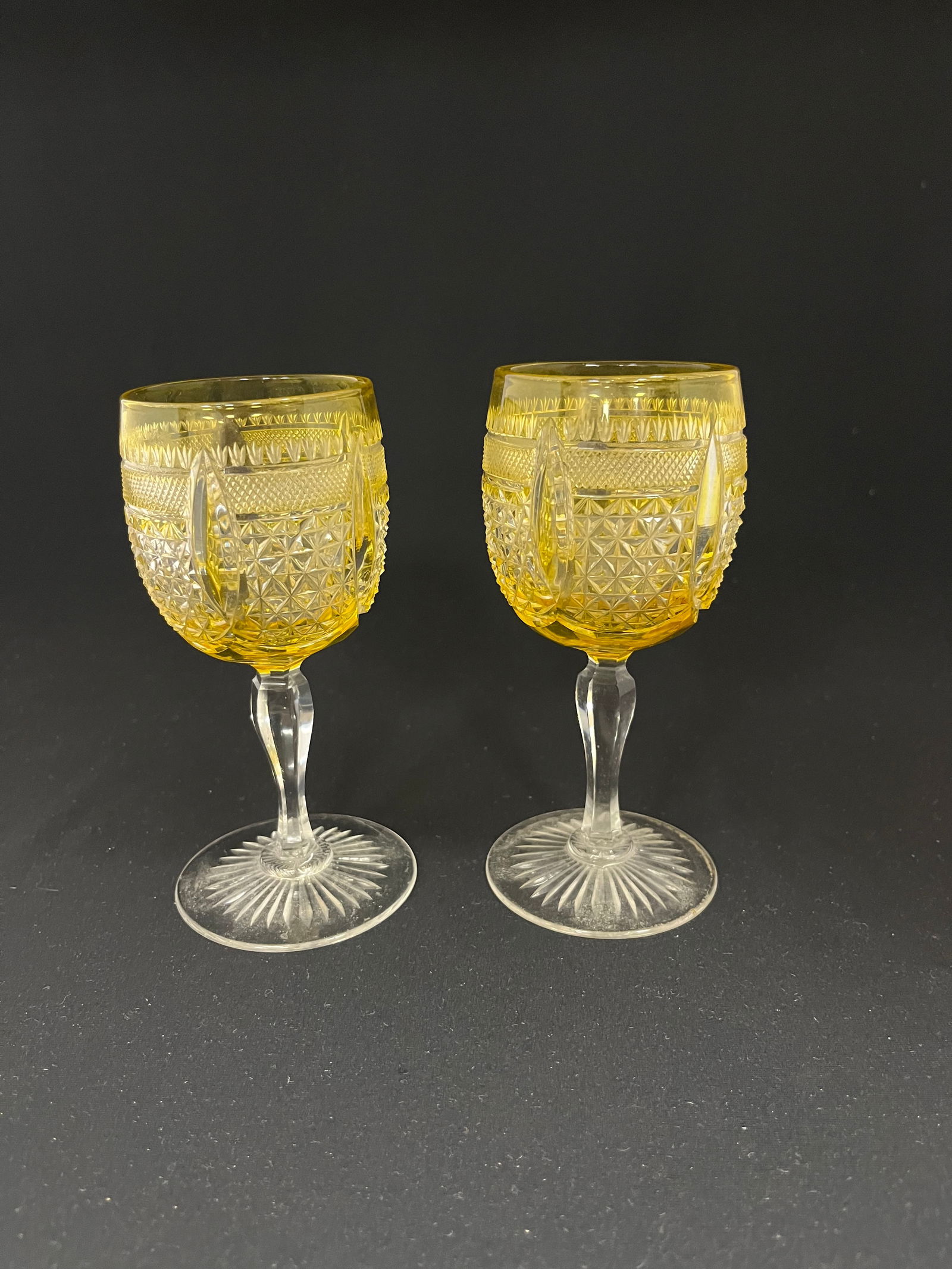 Two amber Cut to Clear: Two amber cut to clear goblets with diamond and cross hatch cuttings, 5 1/2" ht.