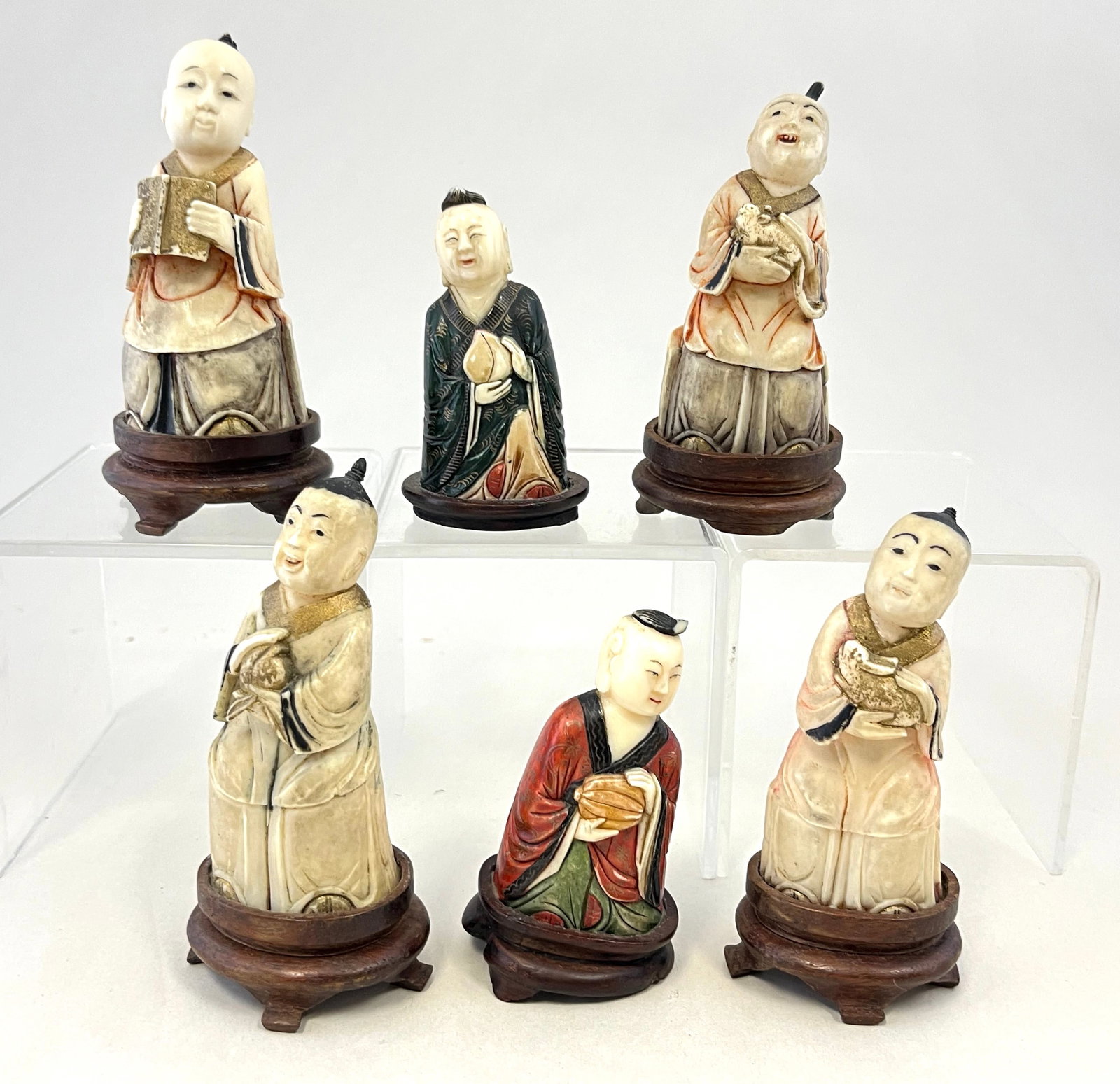 Six Japanese carved sculptures: Six Japanese carved sculptures out of boar tusk, late 19th century, tallest 3 1/4" ht. CONDITION: one with two feet on the wood base missing.