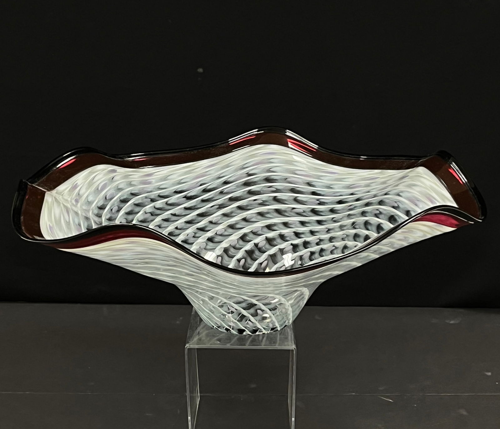 LaChaussee art glass bowl: Dan and Joi La Chaussee art glass bowl in an undulating white pattern on translucent glass with red lip wrap, signed LaChaussee 1999, 21" wude. CONDITION: no chips, cracks, repairs or material defects