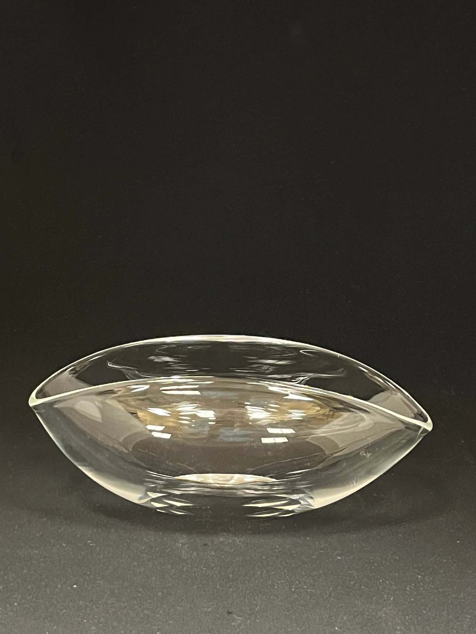 Steuben clear glass bowl: Steuben ovoid clear glass bowl signed Steuben with gift bag and box, 7" long. CONDITION: no chips, cracks, repairs or material defects found. Jaremos attempts to call any material flaw that affects th