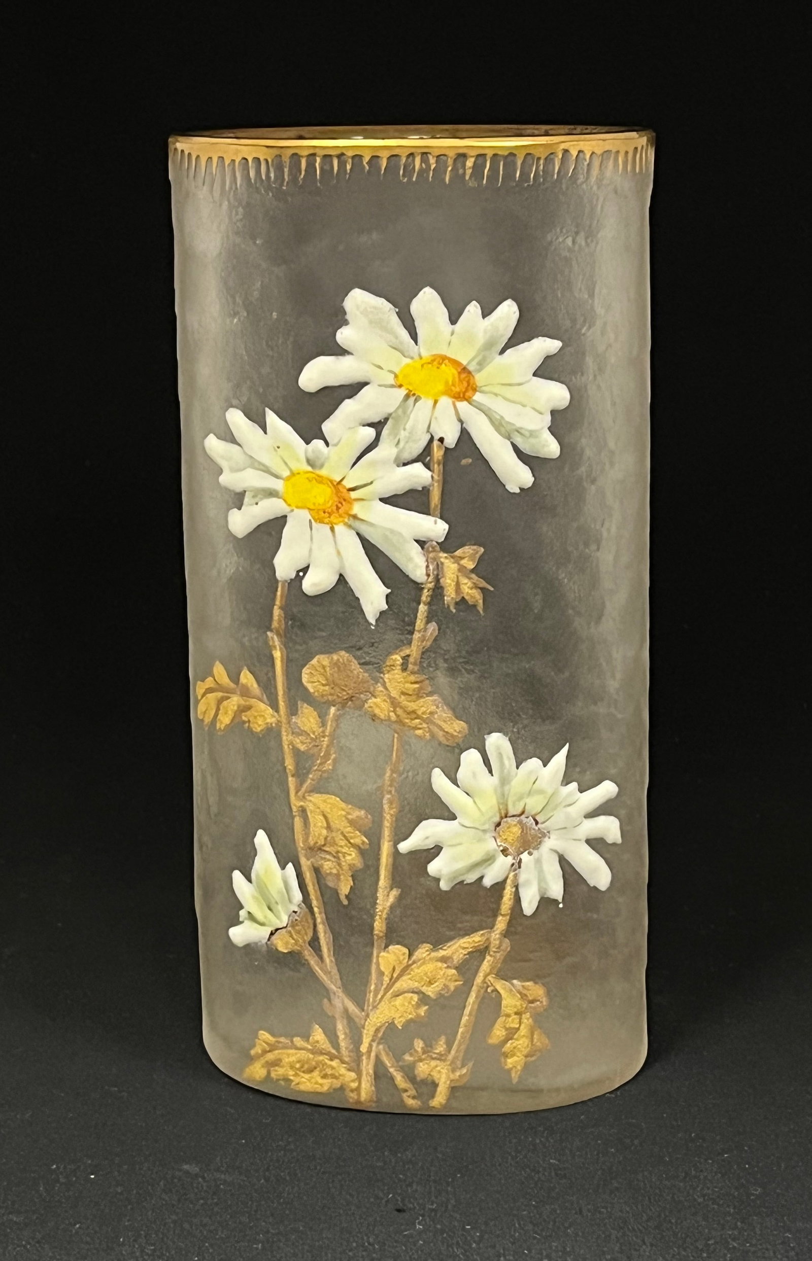 Mont Joye Cameo glass vase: Mont Joye cylindrical form glass vase in textured crystal decorated with 4 gold stemmed white daisy, reverse with two daisies, 8" ht. CONDITION: no chips, cracks, repairs or material defects found. Ja