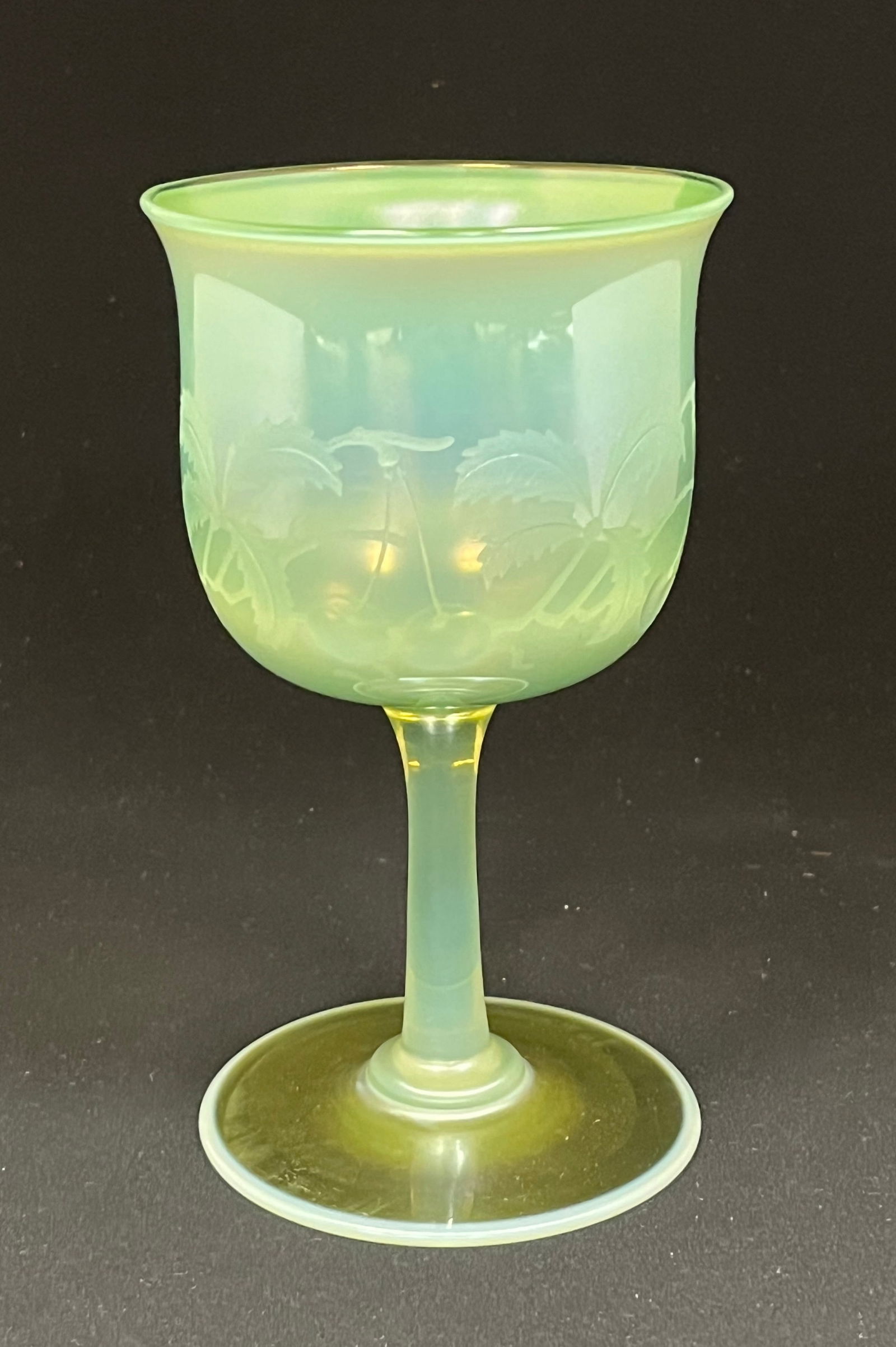 Tiffany Intaglio cut goblet: Tiffany green pastel goblet with etched cherries and leaves; signed 5 LCT Favrile. Ht. 6" CONDITION: no chips, cracks, repairs or material defects found. Jaremos attempts to call any material flaw tha