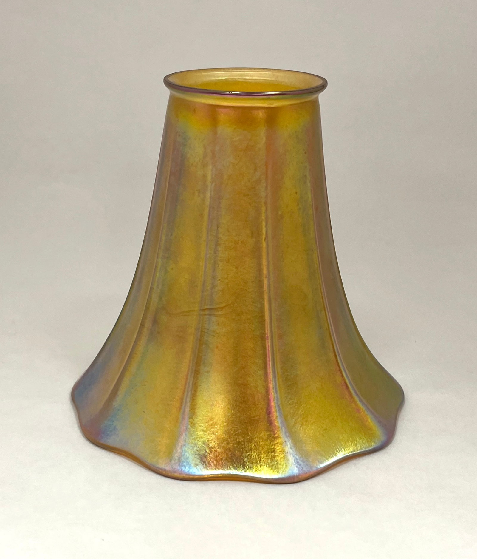 Lustre Art glass shade: Lustre Art iridescent gold glass shade with ribs, fitter 2 1/4" wide, 5" ht. CONDITION: no chips, cracks, repairs or material defects found. Jaremos attempts to call any material flaw that affects the
