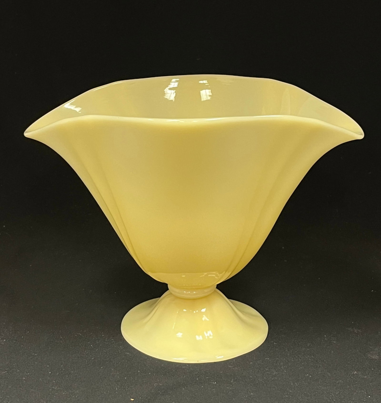 Steuben Ivory glass vase: Steuben footed shell form glass vase in Ivory glass, has a Rockwell Gallery paper label, 6 1/2' ht. CONDITION: no chips, cracks, repairs or material defects found. Jaremos attempts to call any materia