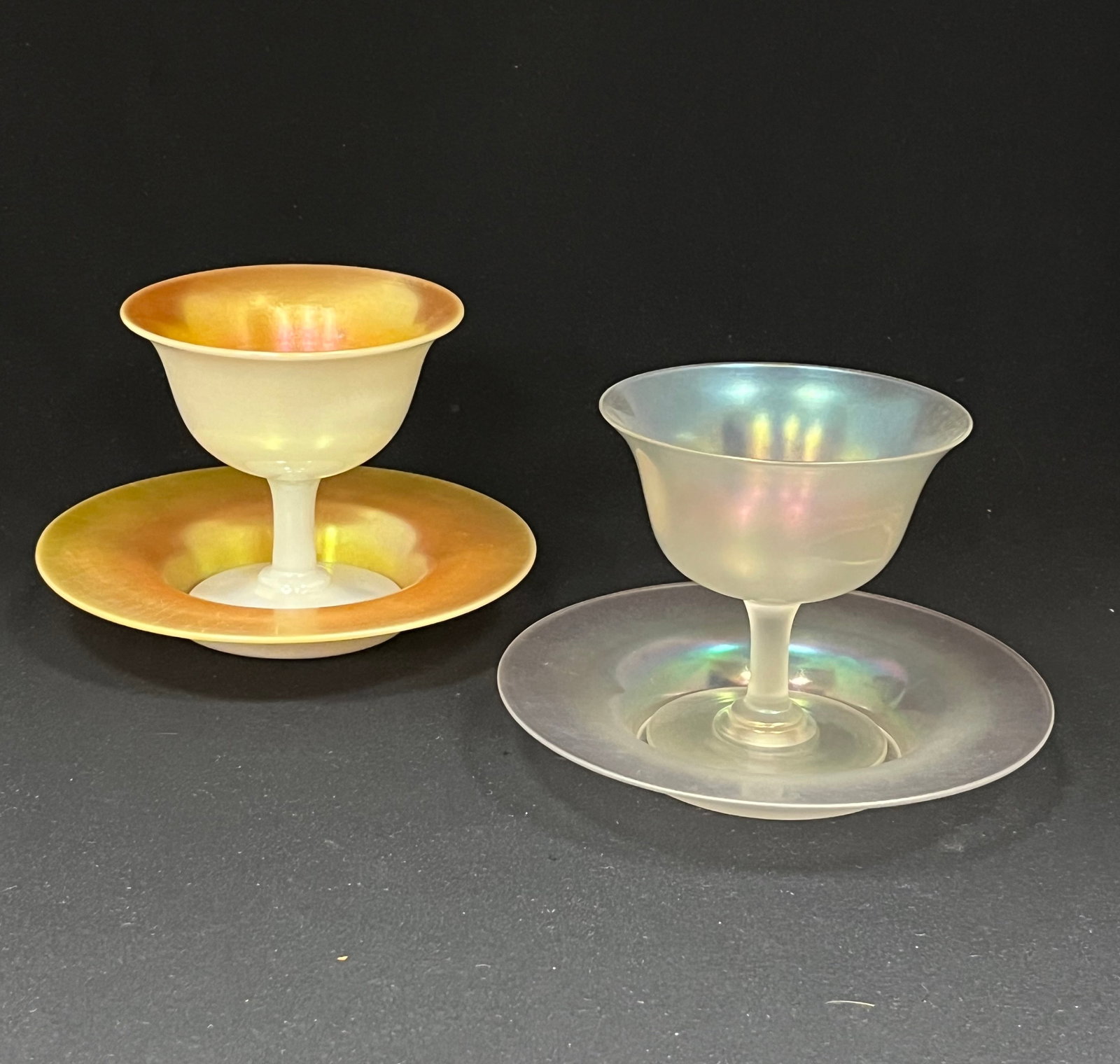 Two Steuben sherbets and plates: Two Steuben footed sherberts and underplates one Gold Aurene over Calcite the other in Verre-de-Soie, 4 1/4" ht. CONDITION: no chips, cracks, repairs or material defects found. Jaremos attempts to cal
