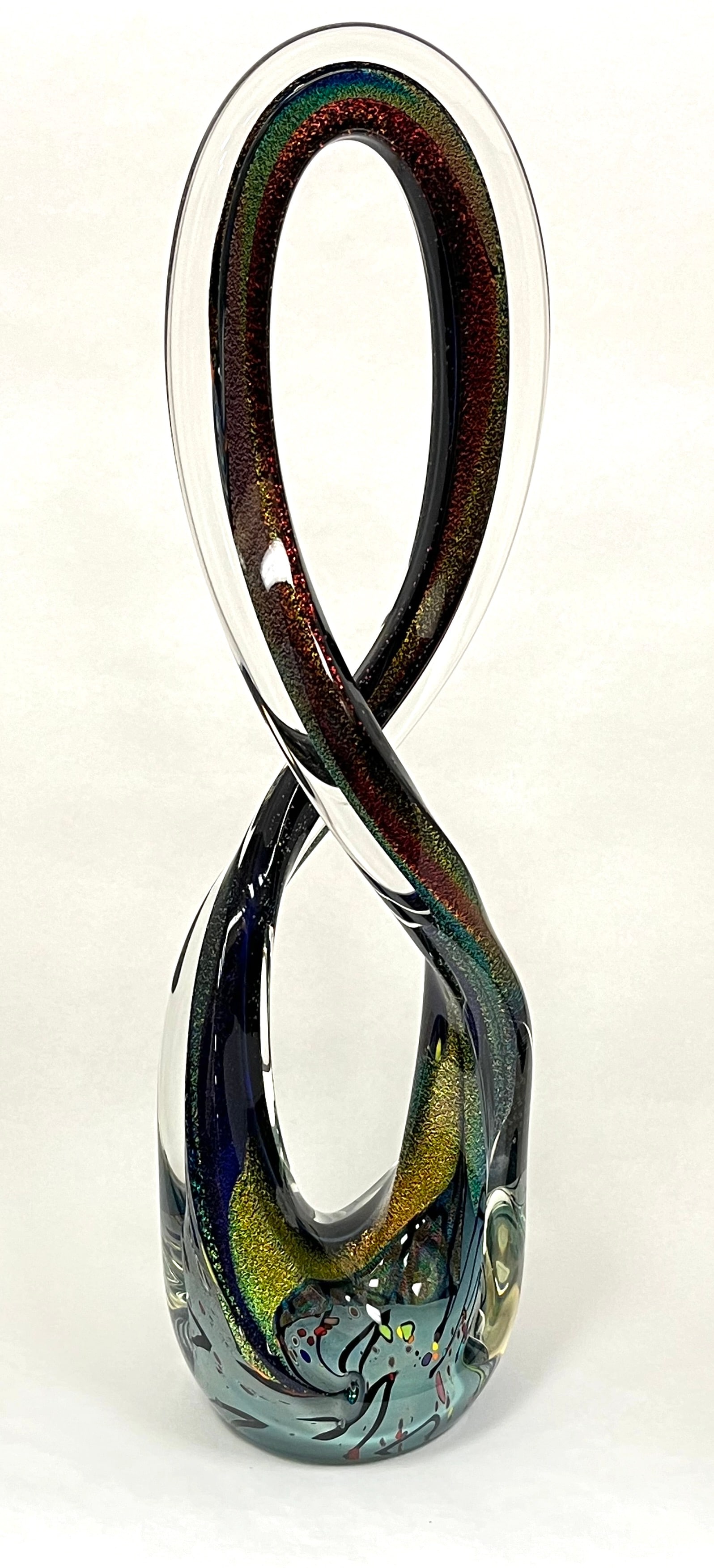 Rolin Karg art glass sculpture: Rolin Karg art glass sculpture in the form of a figure 8 with a dark core decorated with red, blue, yellow and purple aventurine, signed Karg, 22" ht. CONDITION: no chips, cracks, repairs or material 