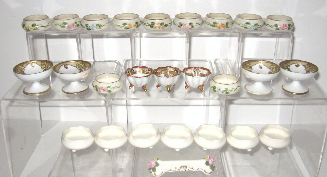 26 piece grouping of porcelain,: including Willets Belleek salts, Nippon salts and a Dresden knife rest.
