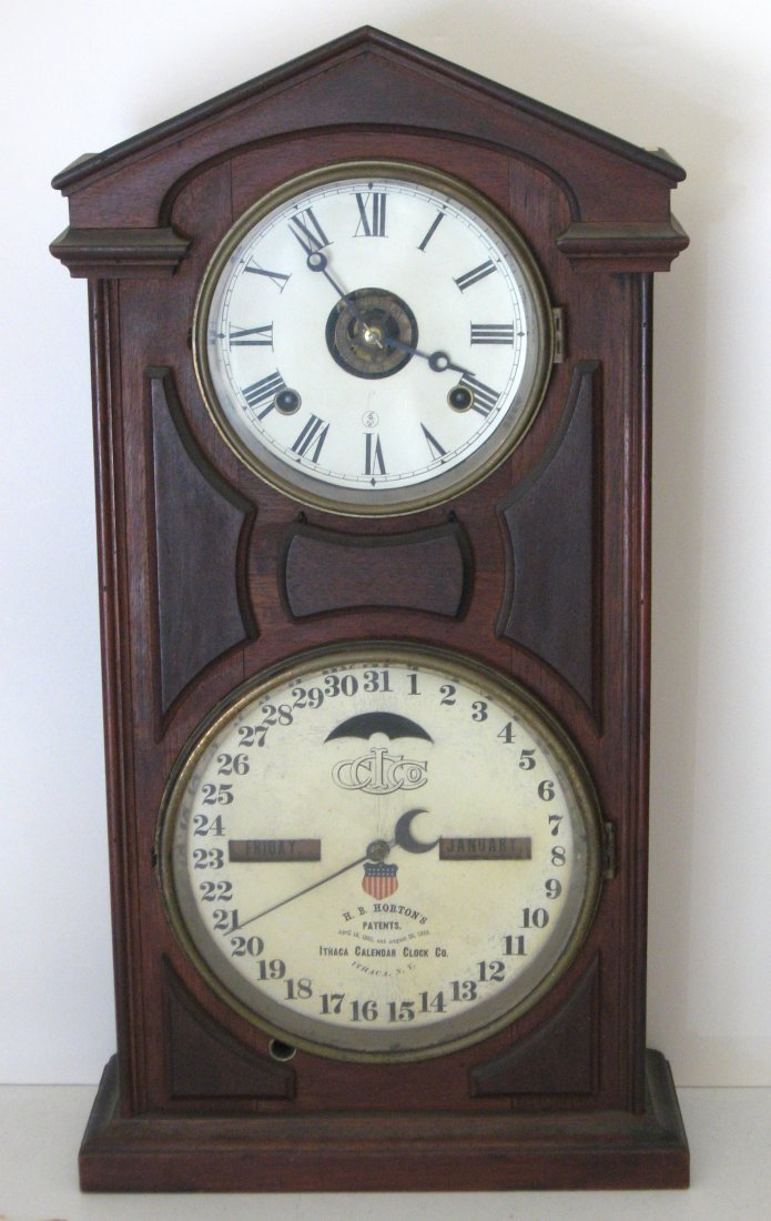 Ithaca #7 Double Dial walnut mantel clock,: circa 1880 with a H. B. Horton calendar, 8 day time and strike with alarm. 23" ht.