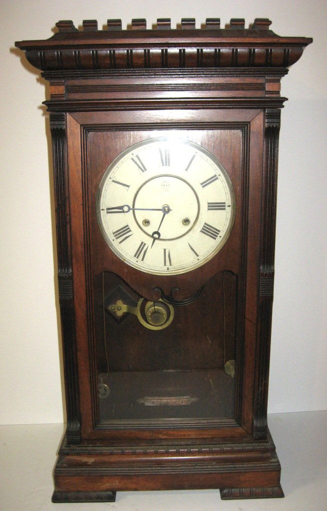 Seth Thomas "Garfield" walnut clock,: circa 1883 dark finish weight driven time and strike with original dial, 30" ht.