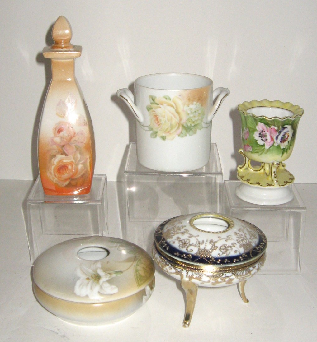 5 piece grouping of vanity porcelain,: including a R. S. Germany perfume, a R. S. Germany hair receiver, a Nippon hair receiver, and more, tallest 7" ht.