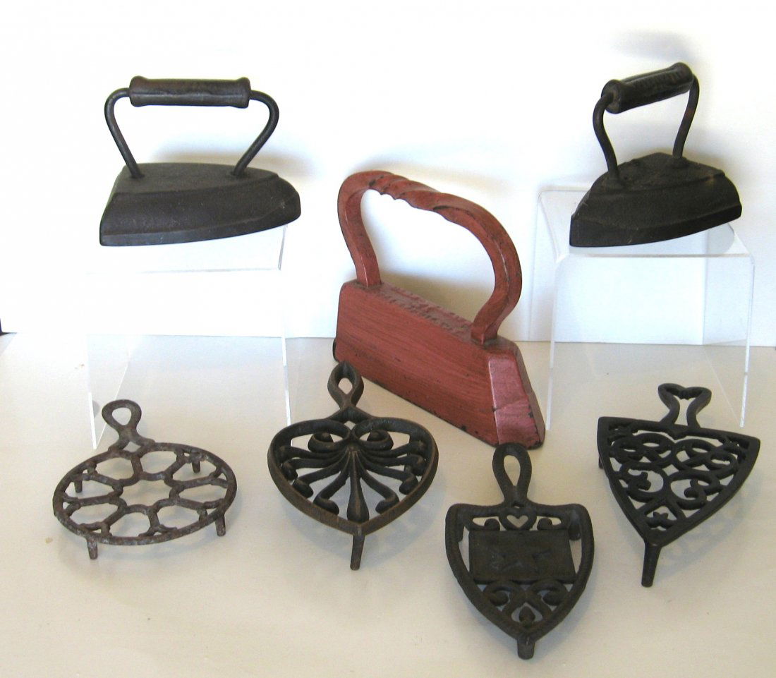 Group of early irons and trivets,: including a large red iron, one marked with a Texas star, one marked Williams Co Ravenna, OH. Largest 9" long.