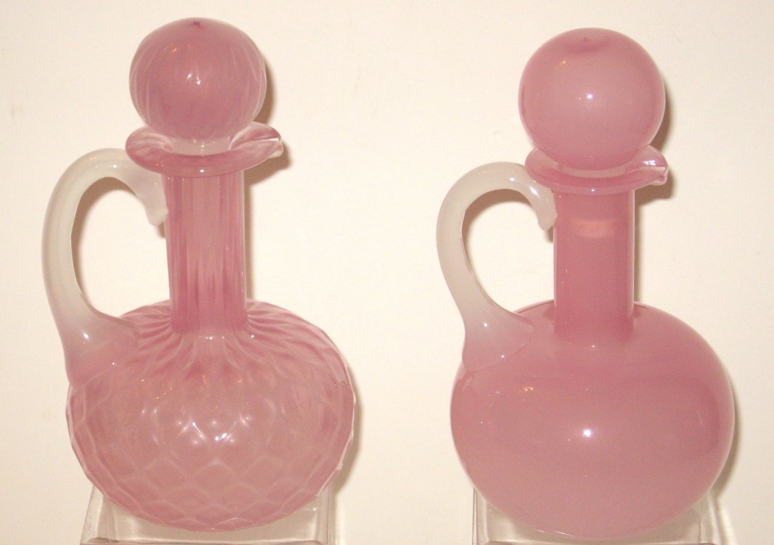 Two Rosaline cruet bottles,: one in the diamond quilted pattern, alabaster handles, 6 1/2" ht. PROVENANCE: Larry Loxterman collection.