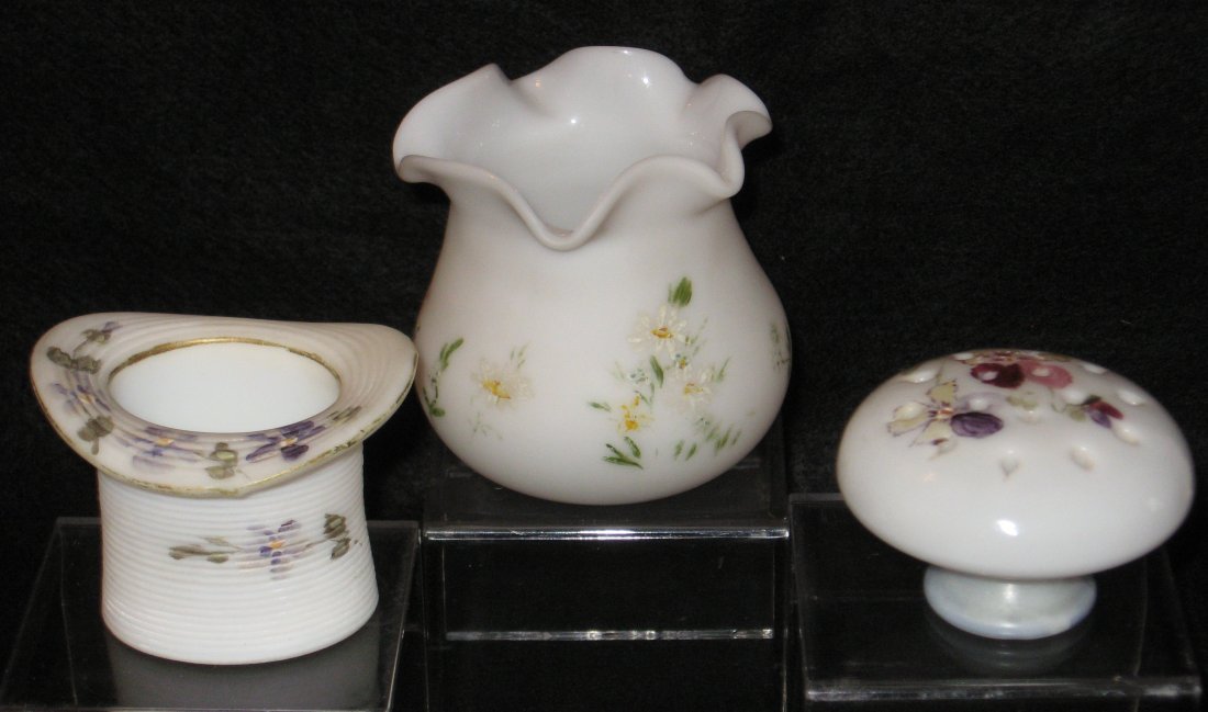 Three decorated Opaline Art Glass items,: including a hat with violets, a mushroom pin holder with pansies, and a ruffle rim vase with daisies, attributed to Pairpoint, tallest 3' ht.