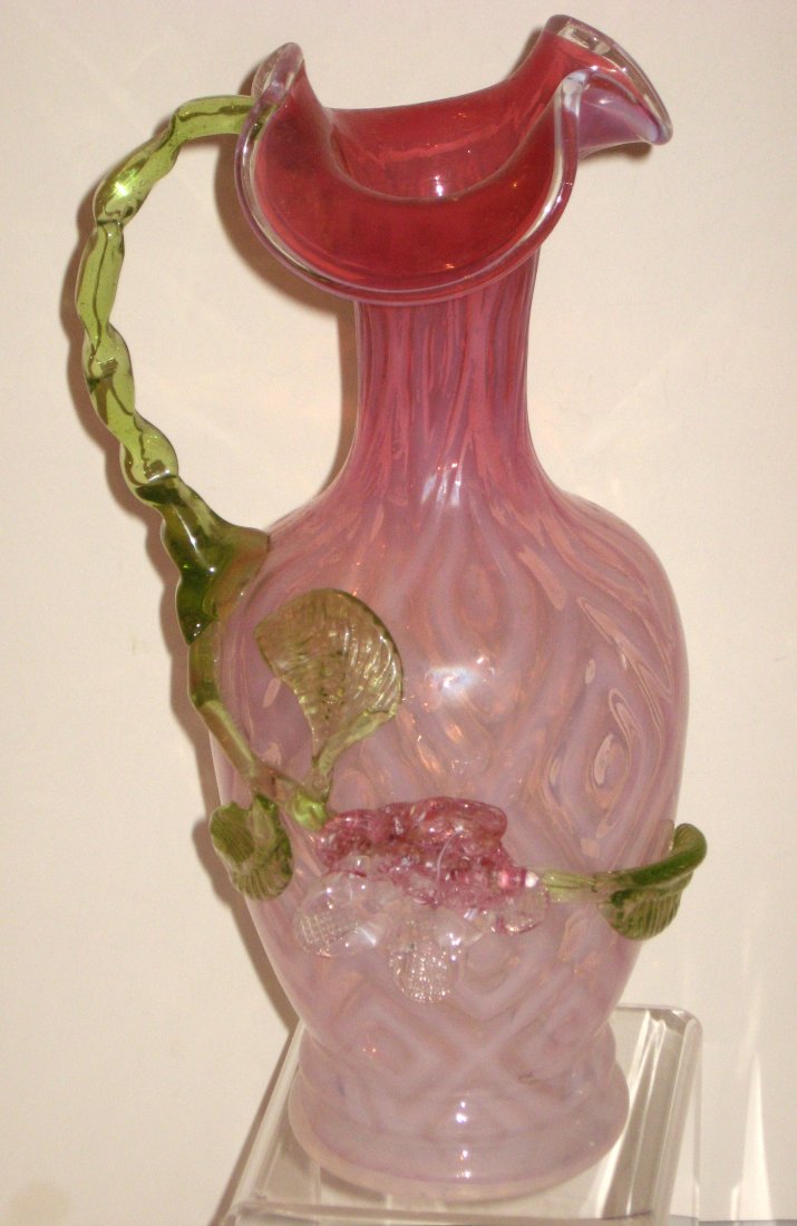 Stevens and Williams opalescent ewer,: cranberry opalescent pitcher in a large diamond pattern adorned with an canary leafy handle and applied rose, 10 1/2" ht.
