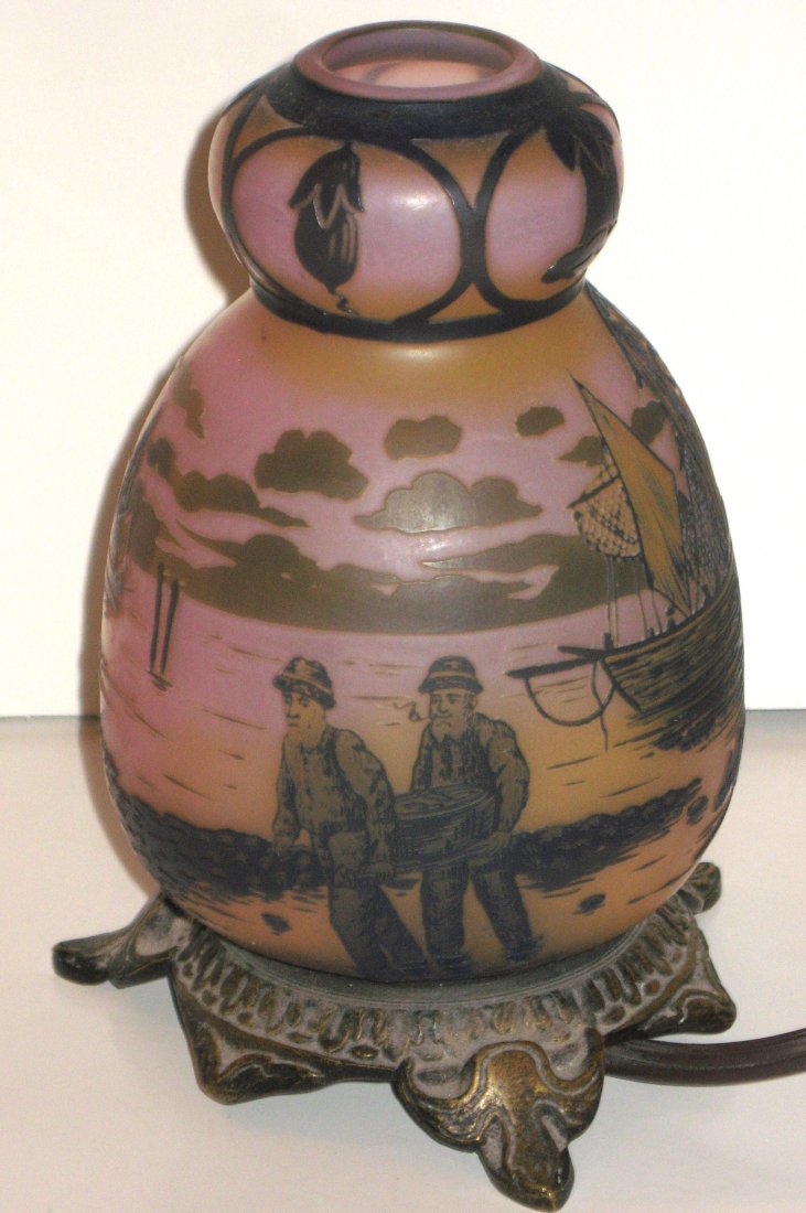 Devez French cameo lamp,: ovoid form in pink glass decorated with a lake scene of fisherman and sail boats, set on a four footed metal base, signed in cameo Devez, 7" ht.