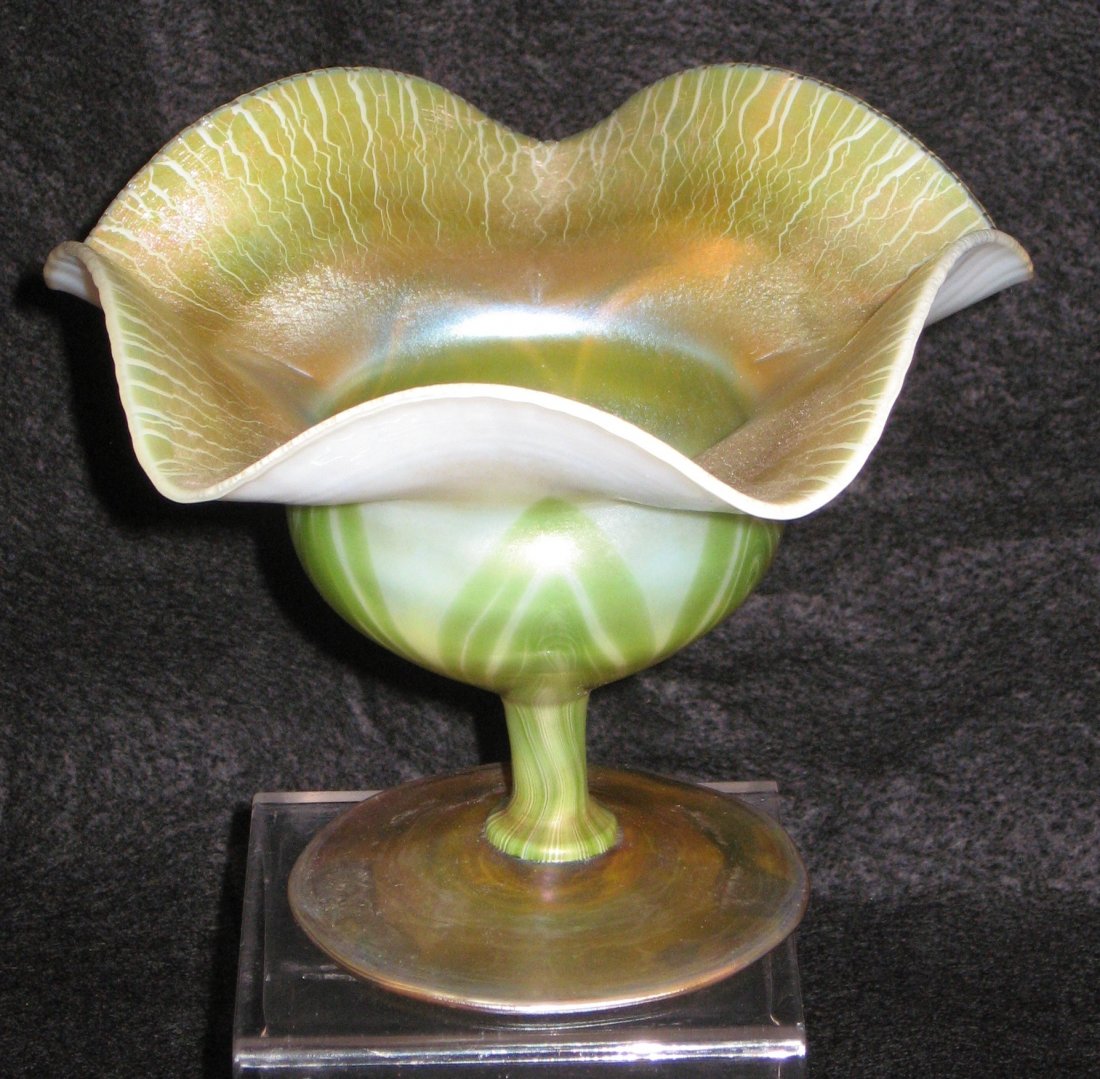Tiffany flower form vase,: squatty compote form in opal glass decorated with green pulled leaves, gold onion skin interior, signed 9352 D L. C. Tiffany-Favrile, 4' ht.