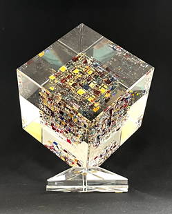 Jon Kuhn glass sculpture: Jon Kuhn "Rainbows End" glass sculpture of a translucent cube with embedded colorful faceted cut shards set on a triangular base, signed Jon Kuhn 1997 with title, 12" ht. CONDITION: no chips, cracks,