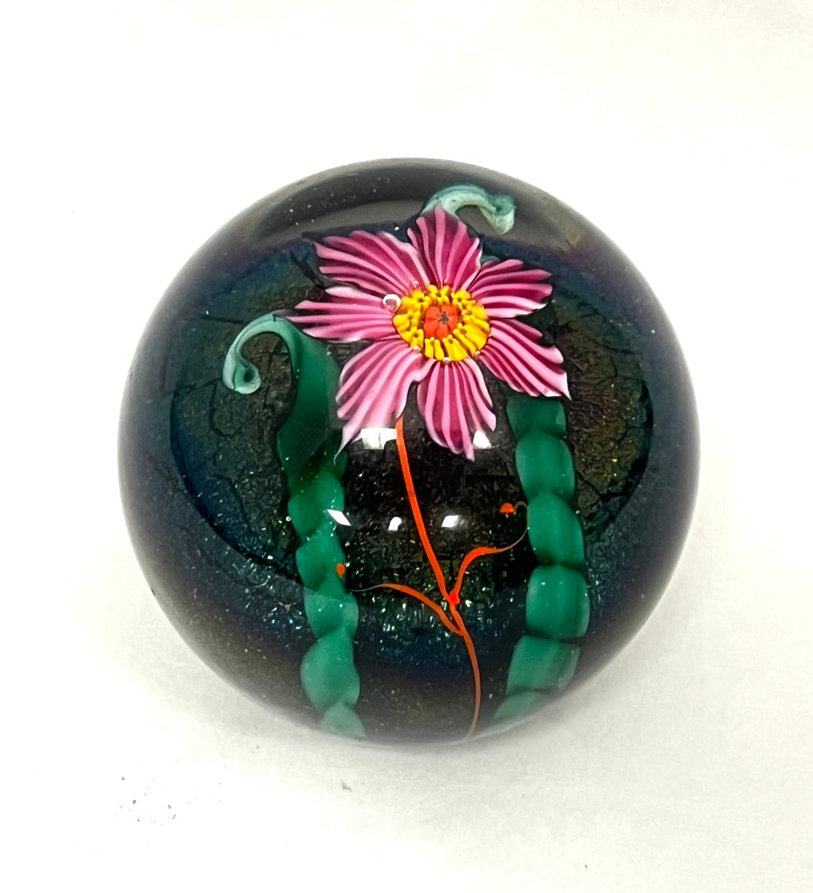 Lundberg glass paperweight: Lundberg translucent paperweight decorated with a single red flower with green leaves over a blue aventurine ground, signed Lundberg 1979, 2 1/2" wide. CONDITION: no chips, cracks, repairs or material