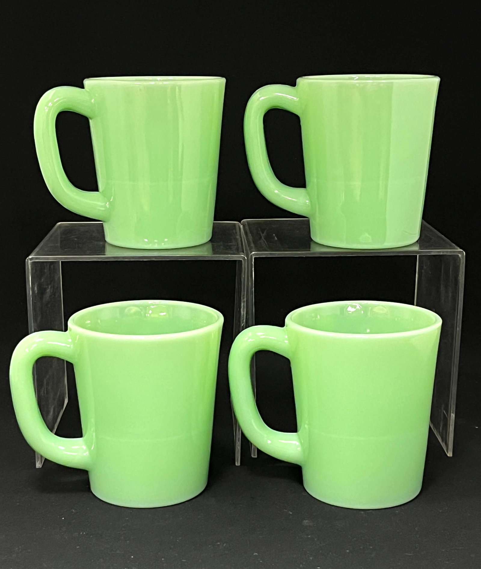 4 Jadite coffee mugs: 4 Jadite coffe mugs; 3 3/4" tall. CONDITION: no chips, cracks, repairs or material defects found, Jaremos attempts to call any material flaw that affects the price, but minor scratches and color varia
