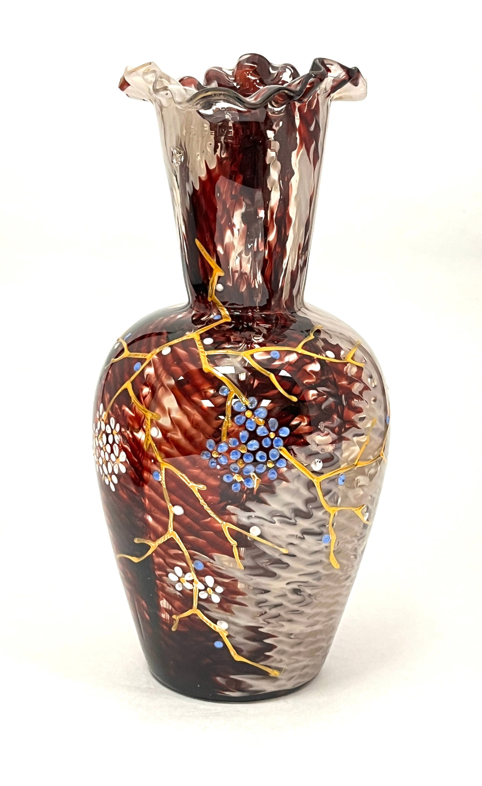 Leveille Art Nouveau Vase: Leveille Art Nouveau vase alternating crimson and white spatter design and gold enameling with blue dots and white daisies and ruffled rim. Attributed Ernest Baptiste Leveille. 8 1/2" tall. CONDITION: