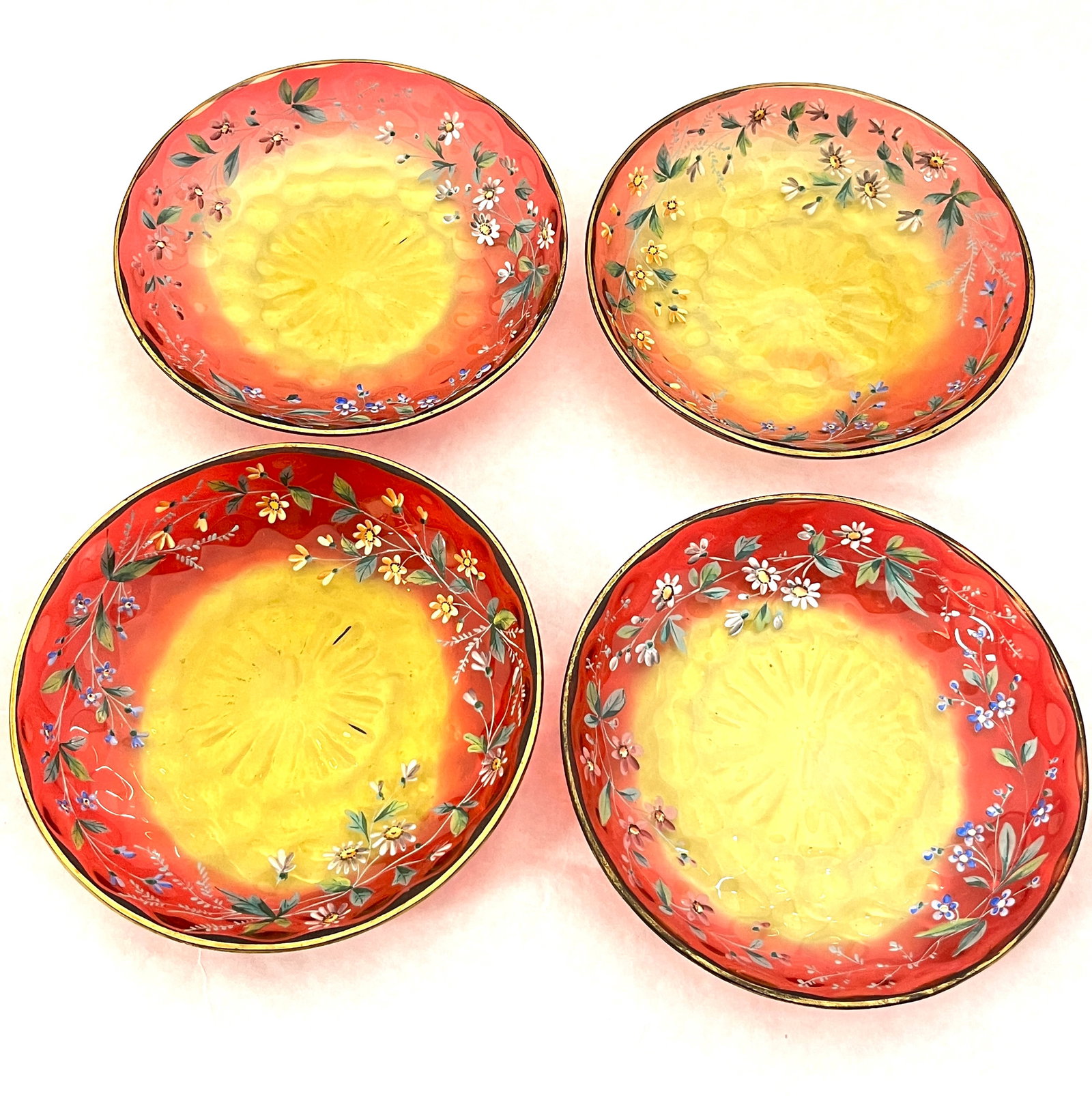 Four decorated Amberina plates: Four Amberina coin spot plates with a band of enameled flowers, 6" wide. CONDITION: no chips, cracks, repairs or material defects found, Jaremos attempts to call any material flaw that affects the pri