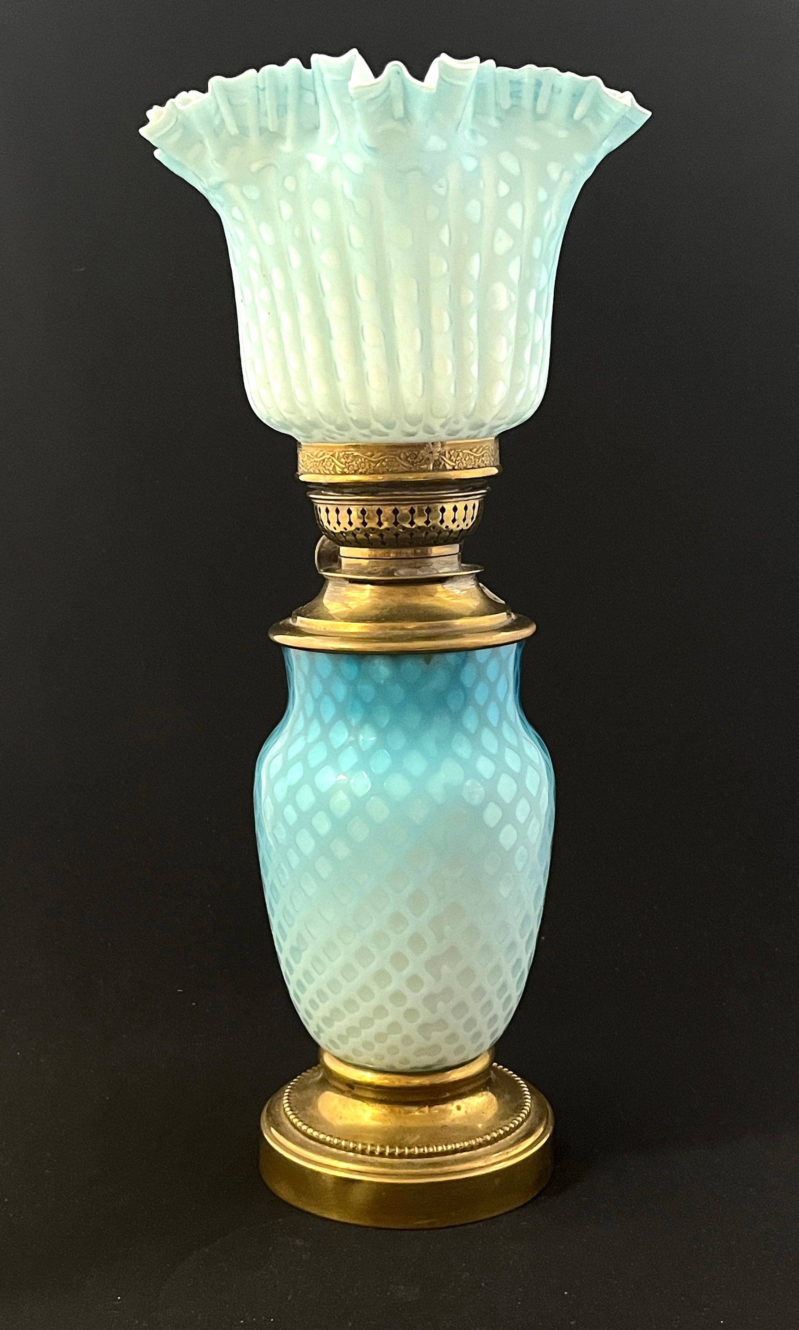 Blue Diamond Quilt Mother of Pearl Lamp: Blue Mother of Pearl diamond quilt lamp, associated ruffled shade; 15" ht. CONDITION: associated shade, no chips, cracks, repairs or material defects found, Jaremos attempts to call any material flaw 