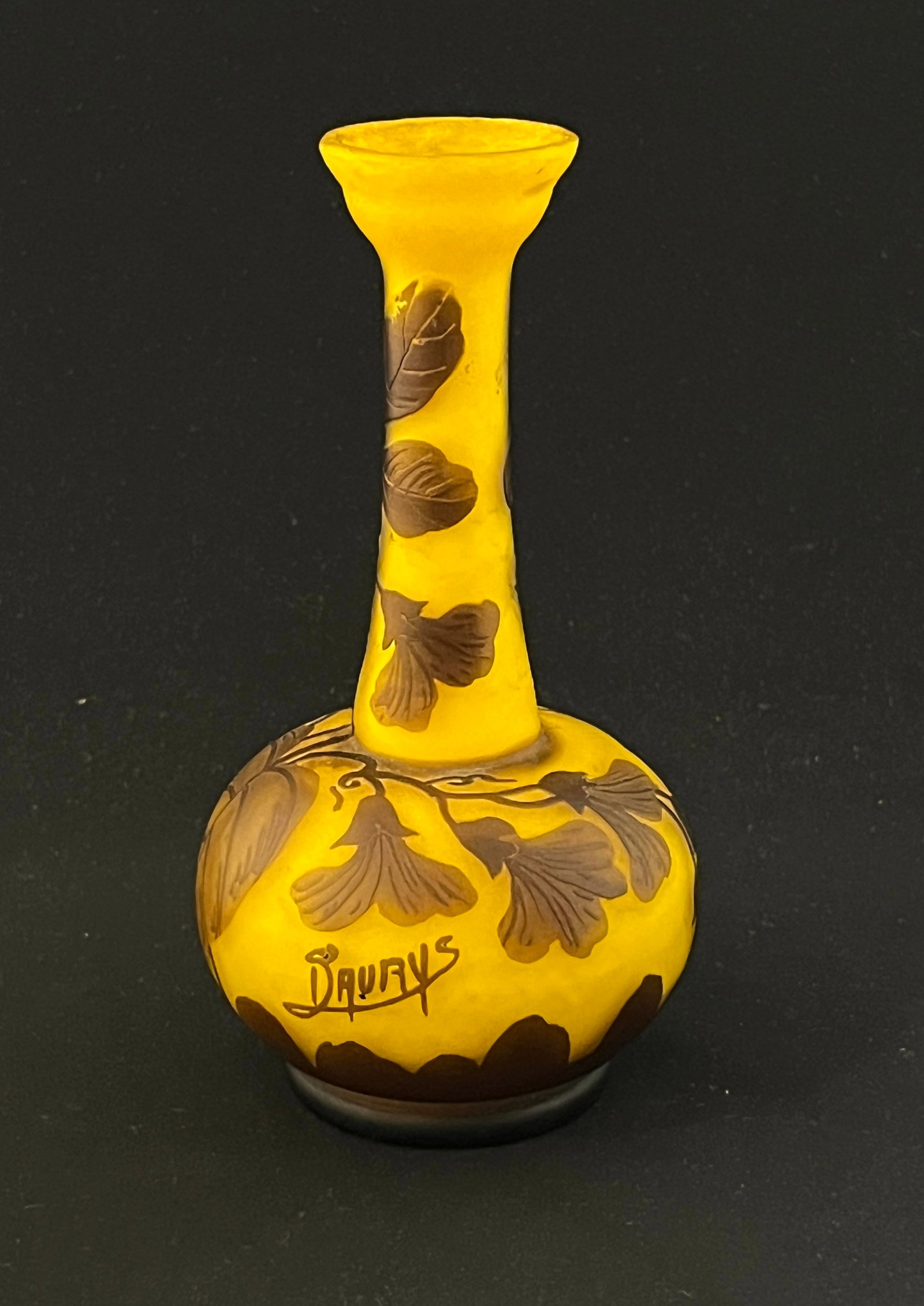 D'Aurys cameo glass vase: D'Aurys bottle form cameo glass vase in yellow glass decorated with a brown branch of leaves and flowers, signed D D/Aury's, 6 1/2" ht. CONDITION: no chips, cracks, repairs or material defects found, 