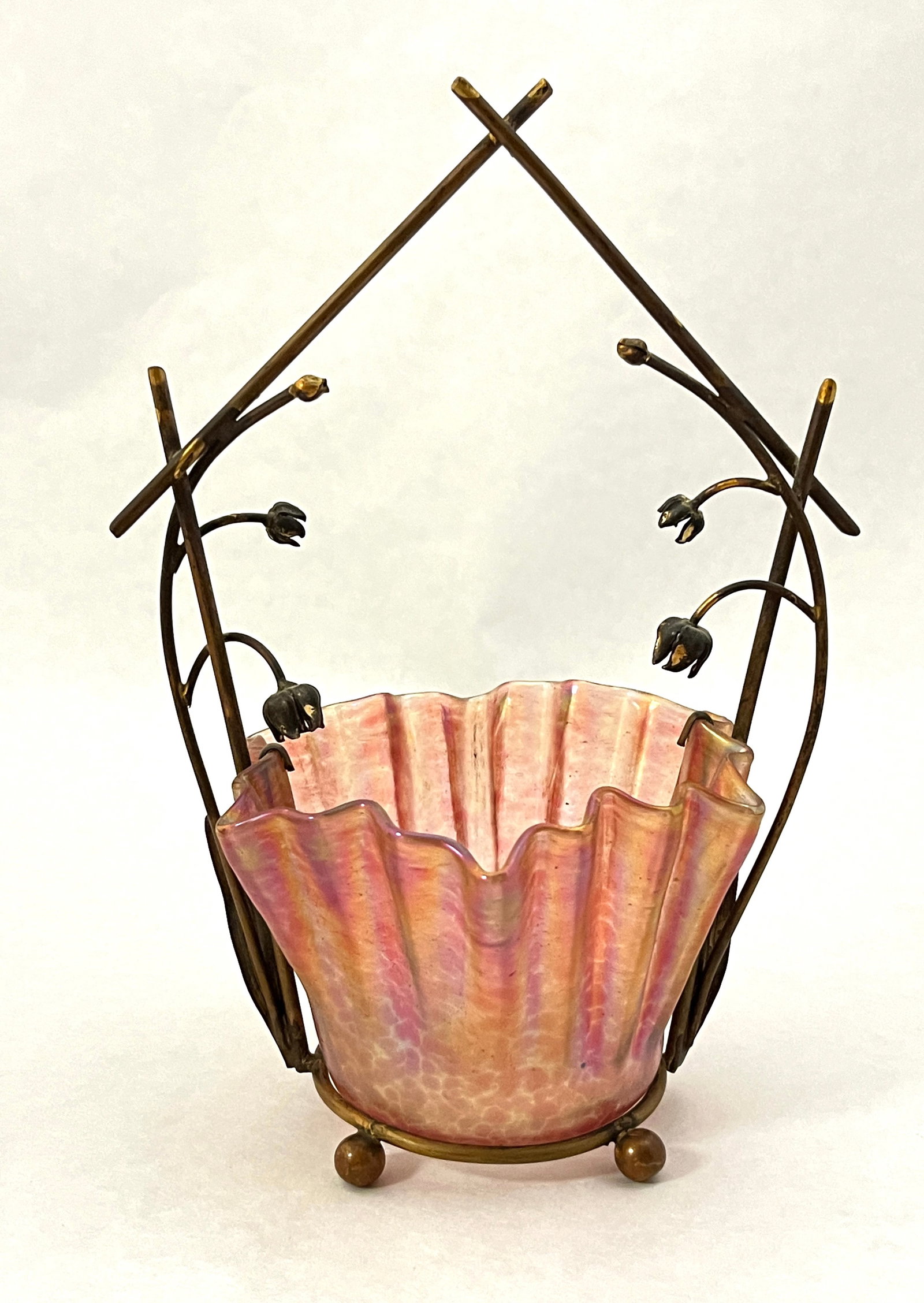 Bohemian red glass and metal basket: Bohemian iridescent red ruffled rim bowl set in a basket caddy, 7 1/2" ht. CONDITION: no chips, cracks, repairs or material defects found, Jaremos attempts to call any material flaw that affects the p