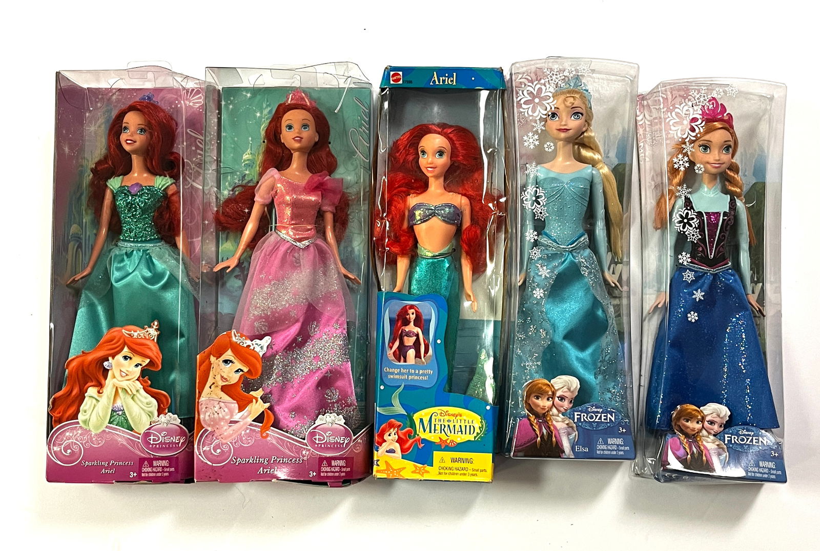 5 Disney "Barbie" Style Dolls: 5 Disney Barbie style dolls including 3 Ariel from Little Mermaid, 2 from Frozen: Anna and Elsa; in original package. CONDITION: some package wear.
