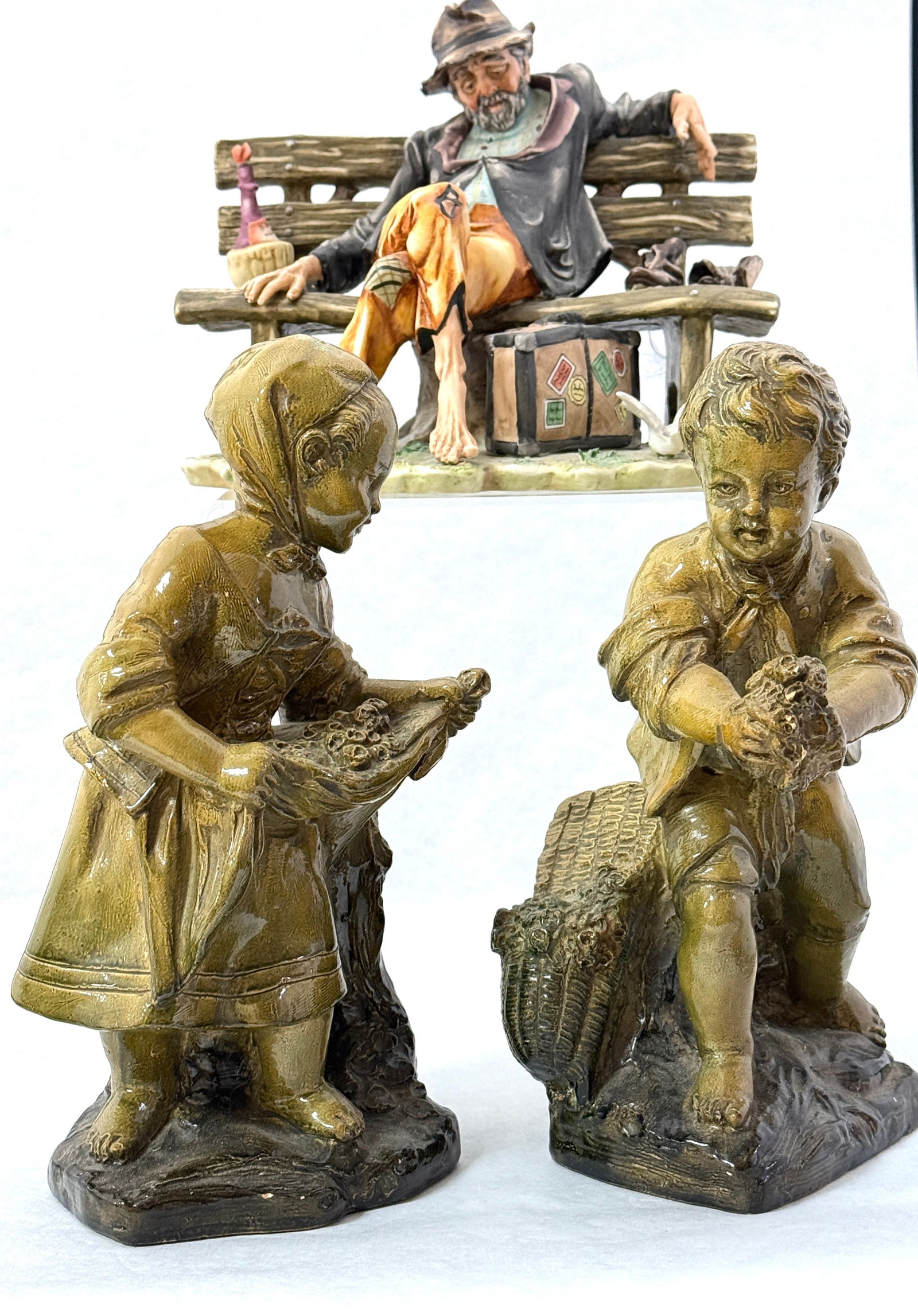 3 Italian Figurines: 3 Italian figurines including 2 Borghese children and 1 Capodimonte Hobo on a Bench; tallest 10 1/2". CONDITION: no chips, cracks, repairs or material defects found, Jaremos attempts to call any mater