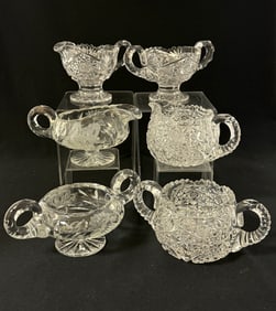 Three sets of cream and sugars