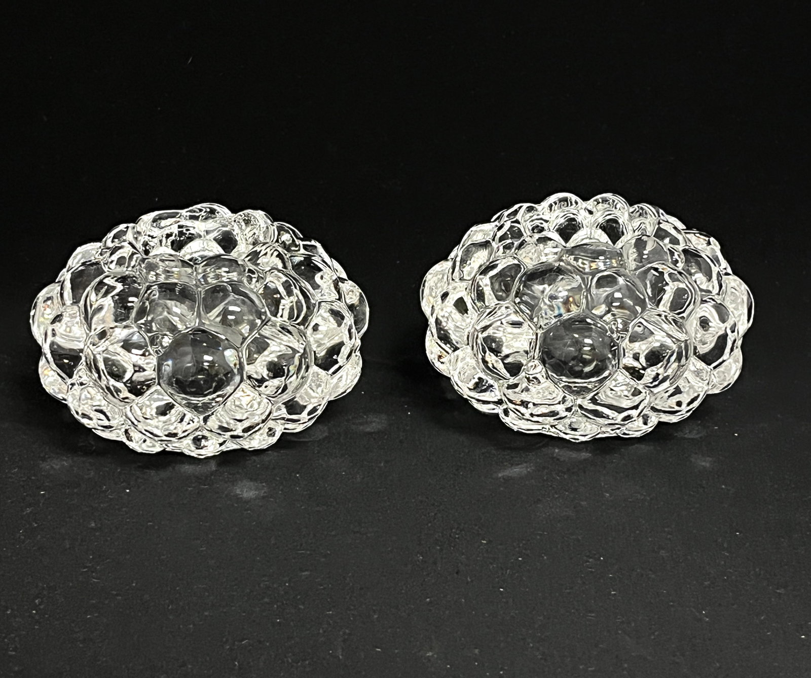 2 Orrefors Bubble candleholders: 2 Orrefors Raspberry bubble translucent candle votives, artist signed Anne Nilsson Orrefors, 4 1/4" wide. CONDITION: no chips, cracks, repairs or material defects found, Jaremos attempts to call any m