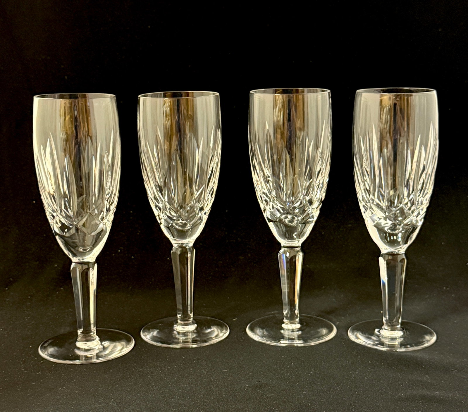 4 Waterford Champaign Flutes: 4 Waterford champaign flutes, all signed; 7 1/2" ht. CONDITION: no chips, cracks, repairs or material defects found, Jaremos attempts to call any material flaw that affects the price, but minor