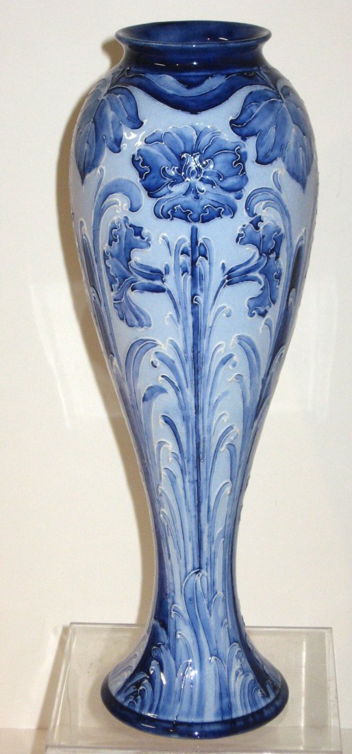 Moorcroft Macintyre Florian ware vase,: cylindrical blue vase decorated with stemmed Chrysanthemums, marked with a wing banner Florian Ware Macintyre & Co. Burslem England Rd No. 326468 and carries a William Moorcroft signature, 11 1/2" ht.