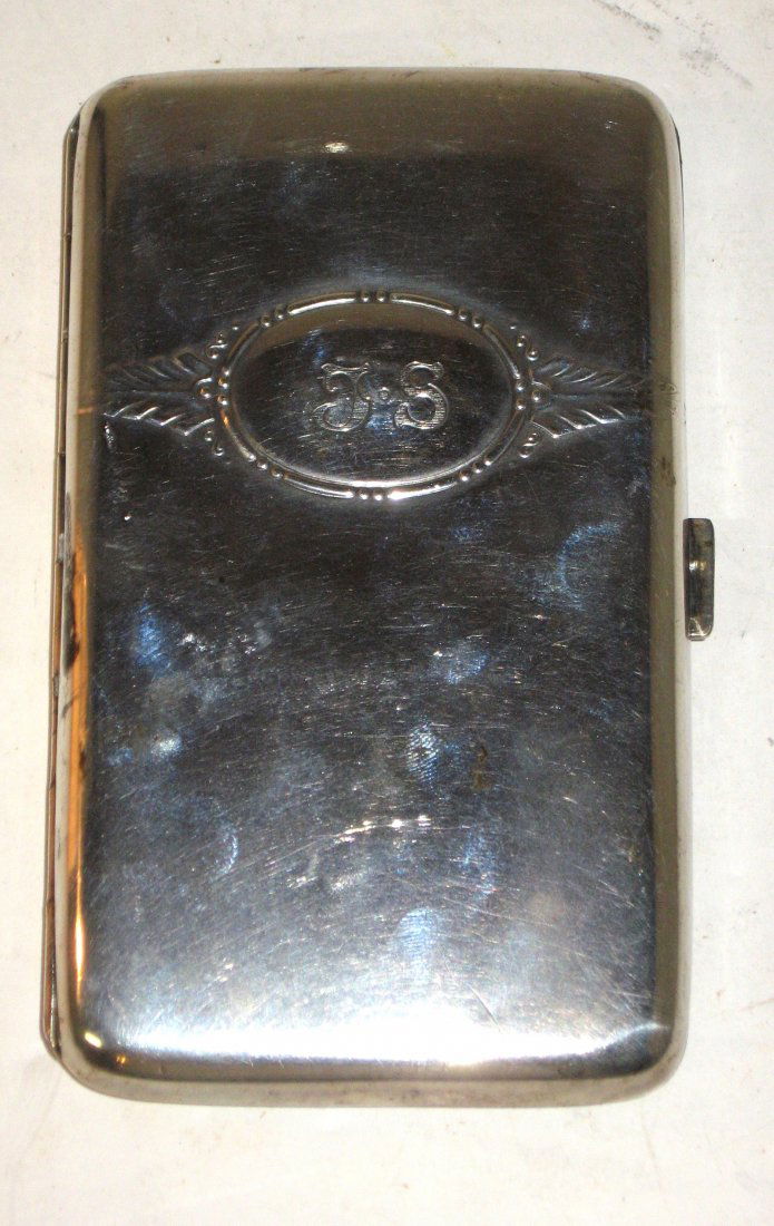 Sterling flip lid cigar case,: rectangular form with a monogram medallion J S, marked 800 on clasp, 7.4oz. 5 1/2" long.