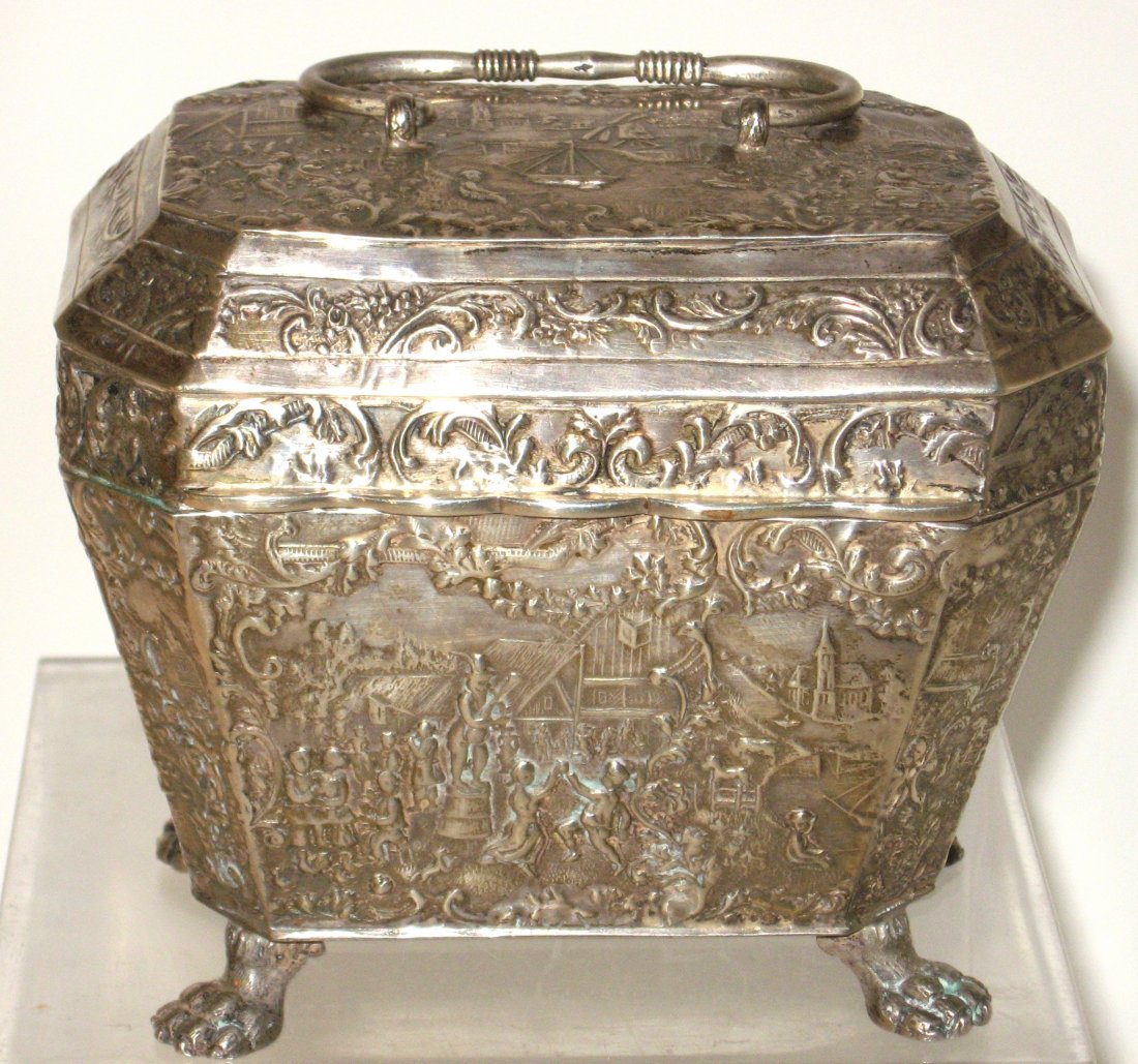 Dutch Silver casket shape box,: casket box with lion paw feet decorated all over with scrolling framed scenes of windmills, sailing ships, villages, and dancing people, marked with the lion and key trademark, approx 9.5 oz. 4 1/2" l