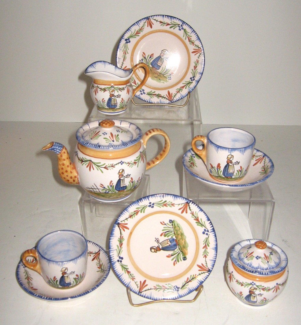 (9) Piece Child's Tea set in Quimper style: including: teapot, sugar, lidded sugar, creamer, (2) cups and saucers and (2) plates. Set made by artist of note, Cathy Schermer. Marked C. Schermer. Diminutive size. Late 20th C.