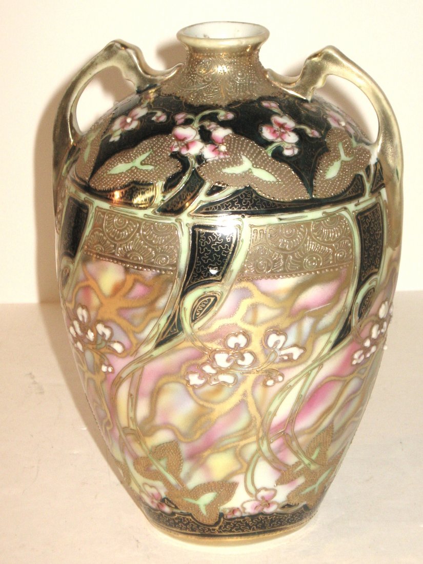 Fine Nippon two handle vase,: decorated with gilt highlighted mistletoe set against a black panel and striated pink and green background, marked, 8" ht.
