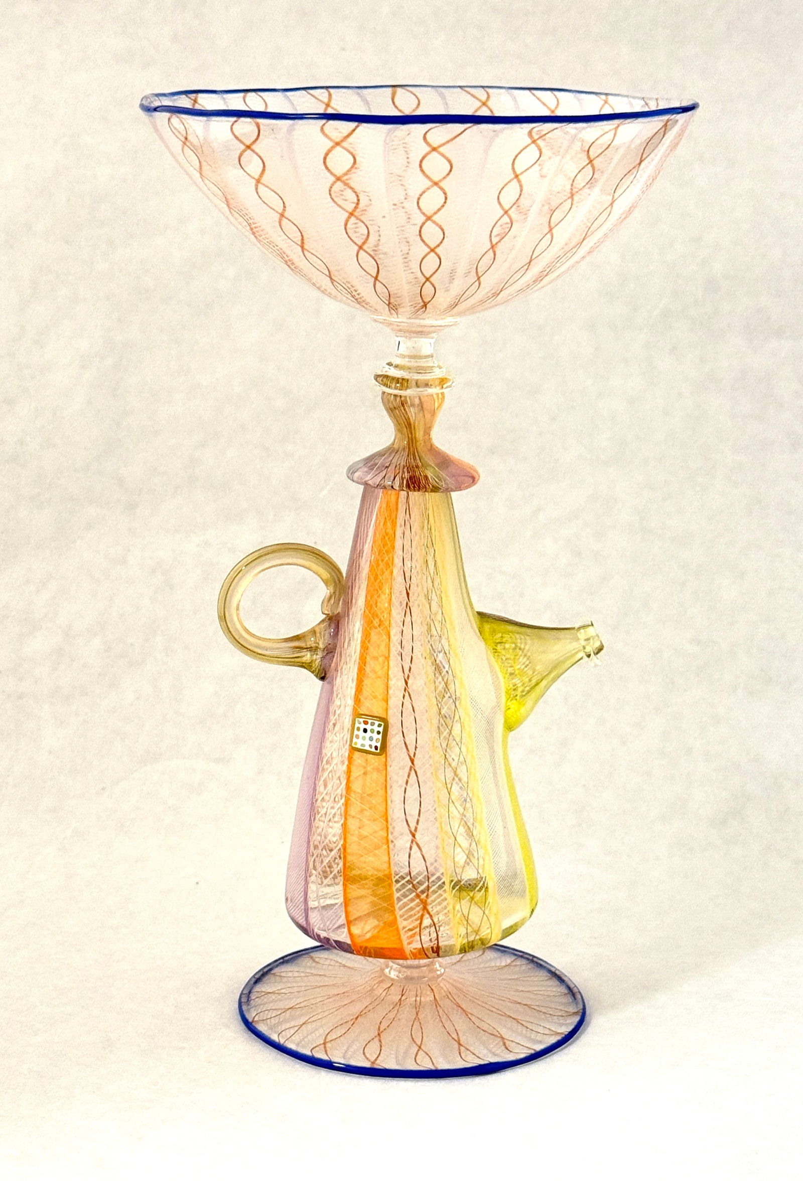 Richard Marquis Teapot Goblet: Richard Marquis teapot goblet in colorful latticino and blue lip wrap, signed Marquis 1980; 9" ht. PROVENANCE: Habitat Jan 28 2022 sale. CONDITION: no chips, cracks, repairs, or material defects found
