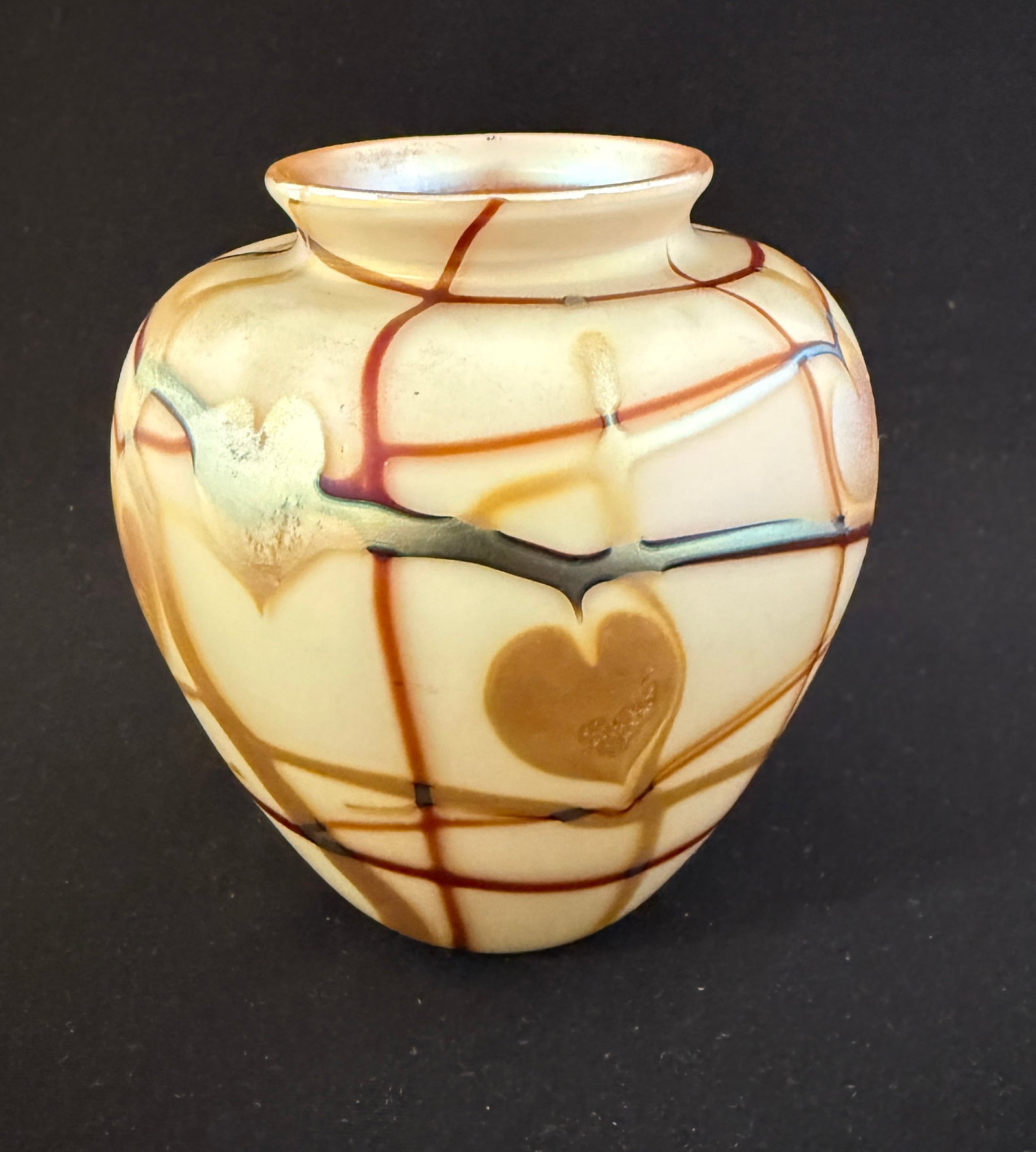 Carlson Art Glass Vase: Carlson cream colored ovoid vase decorated with gold hearts on Crimson vines. Signed Carlson 79, 4 1/2" ht. CONDITION: no chips, cracks, repairs, or material defects found, Jaremos attempts to call an