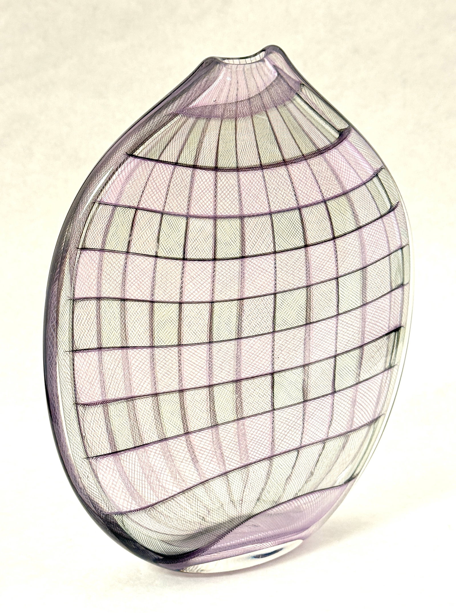 Latticino Kurt Walrath vase: Flat sided and twisted glass vase in a purple latticino design, signed Kurt Walrath; 8 1/4" ht. CONDITION: no chips, cracks, repairs or material defects found, Jaremos attempts to call any material fl