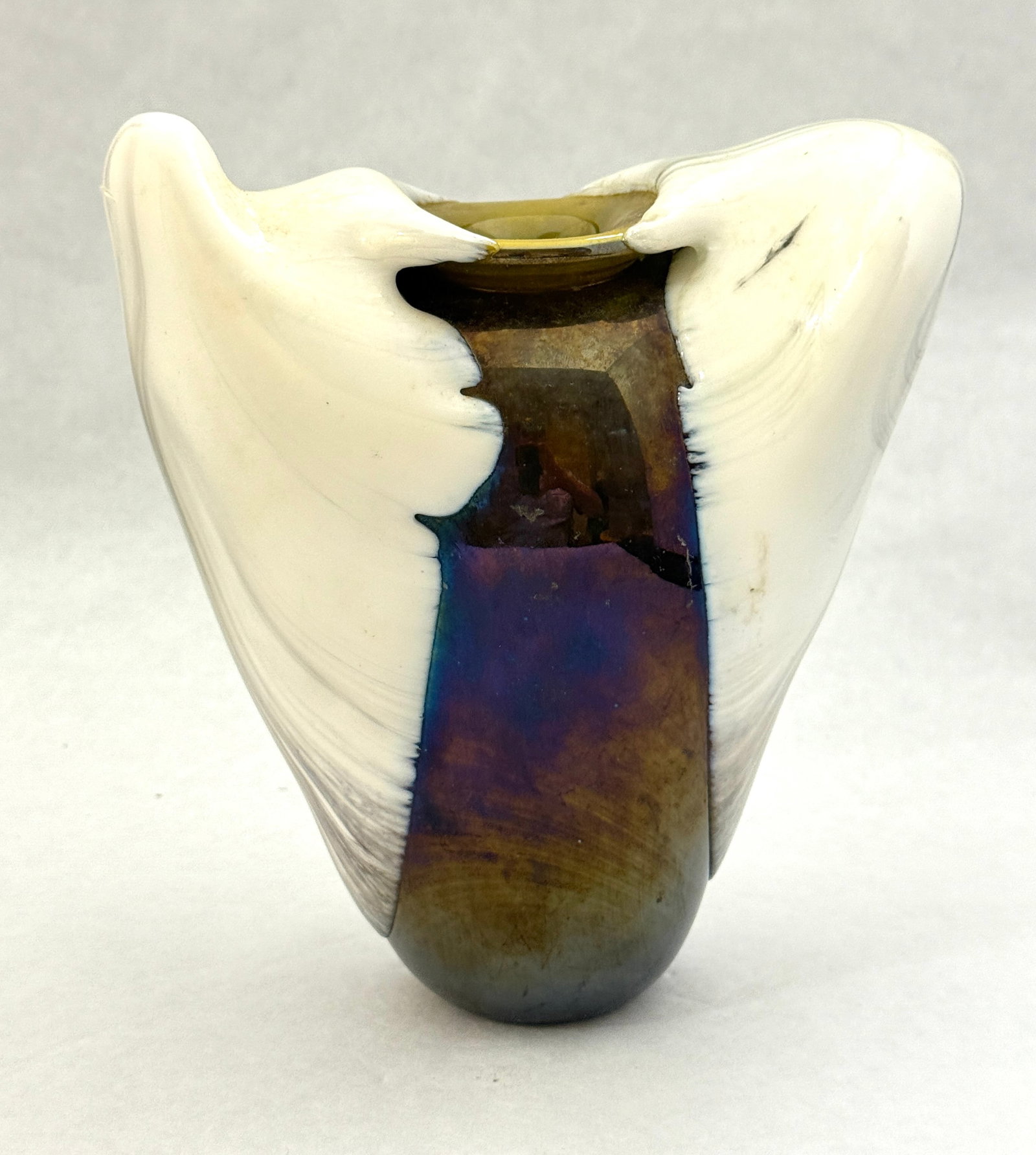 Ritter Art Glass Vase: Ritter freeform iridescent purple vase with white drips, signed Richard Ritter; 8 1/4" ht. at tallest point. CONDITION: no chips, cracks, repairs, or material defects found, Jaremos attempts to call a